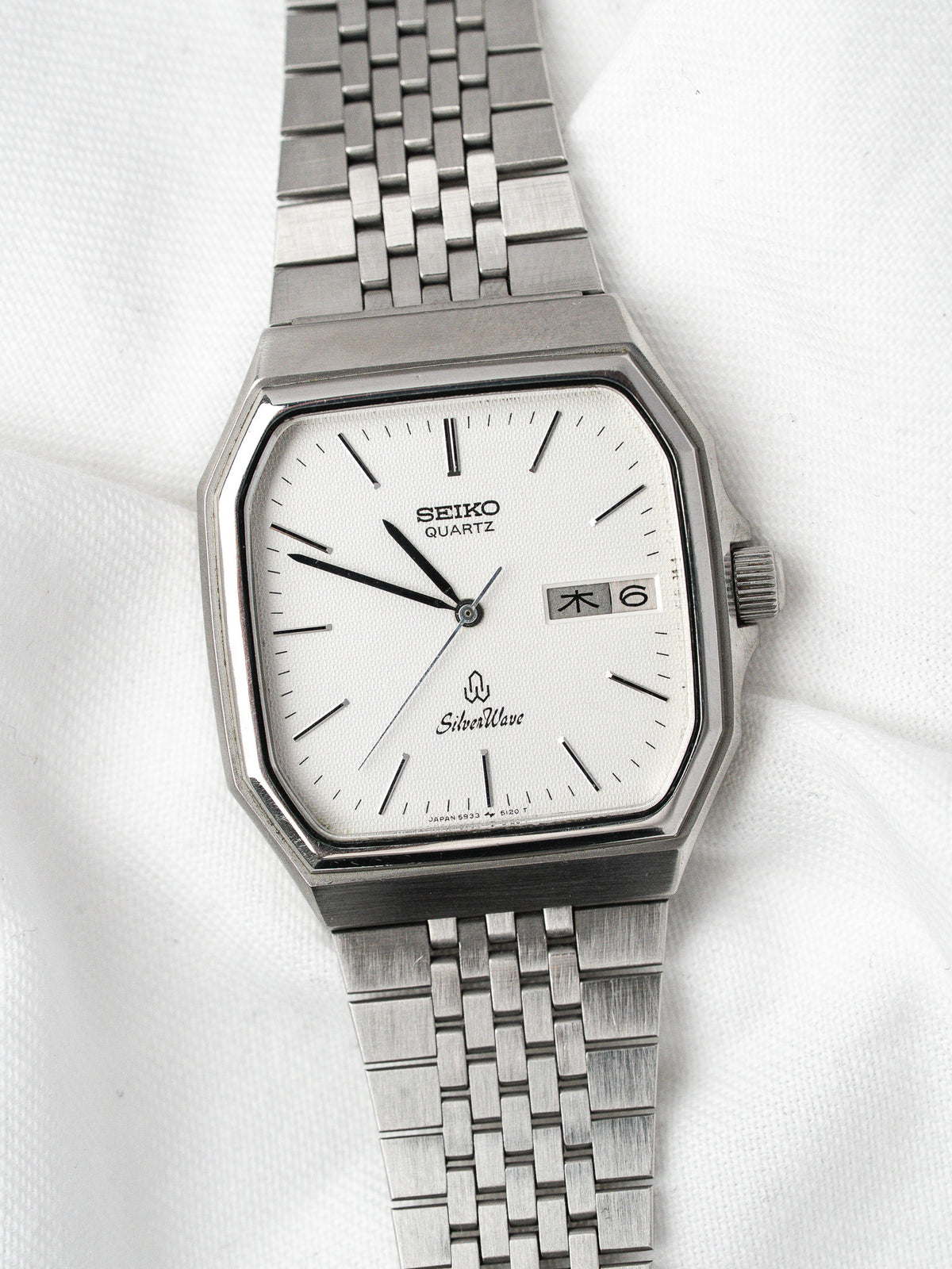 Seiko SilverWave vintage quartz watch with white dial, octagonal case, and metal bracelet on white background