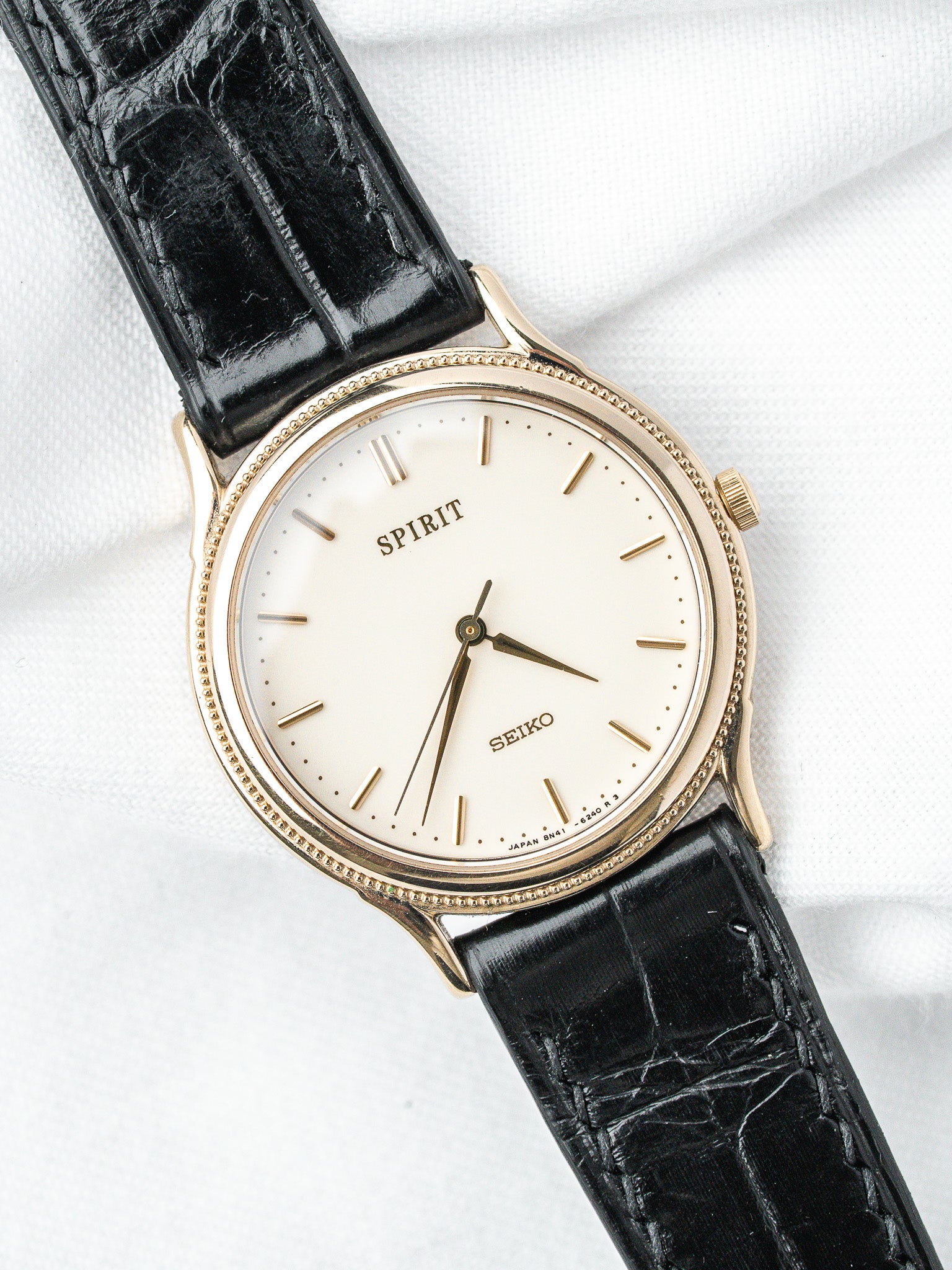 Seiko Spirit vintage watch with gold case, white dial, black alligator strap