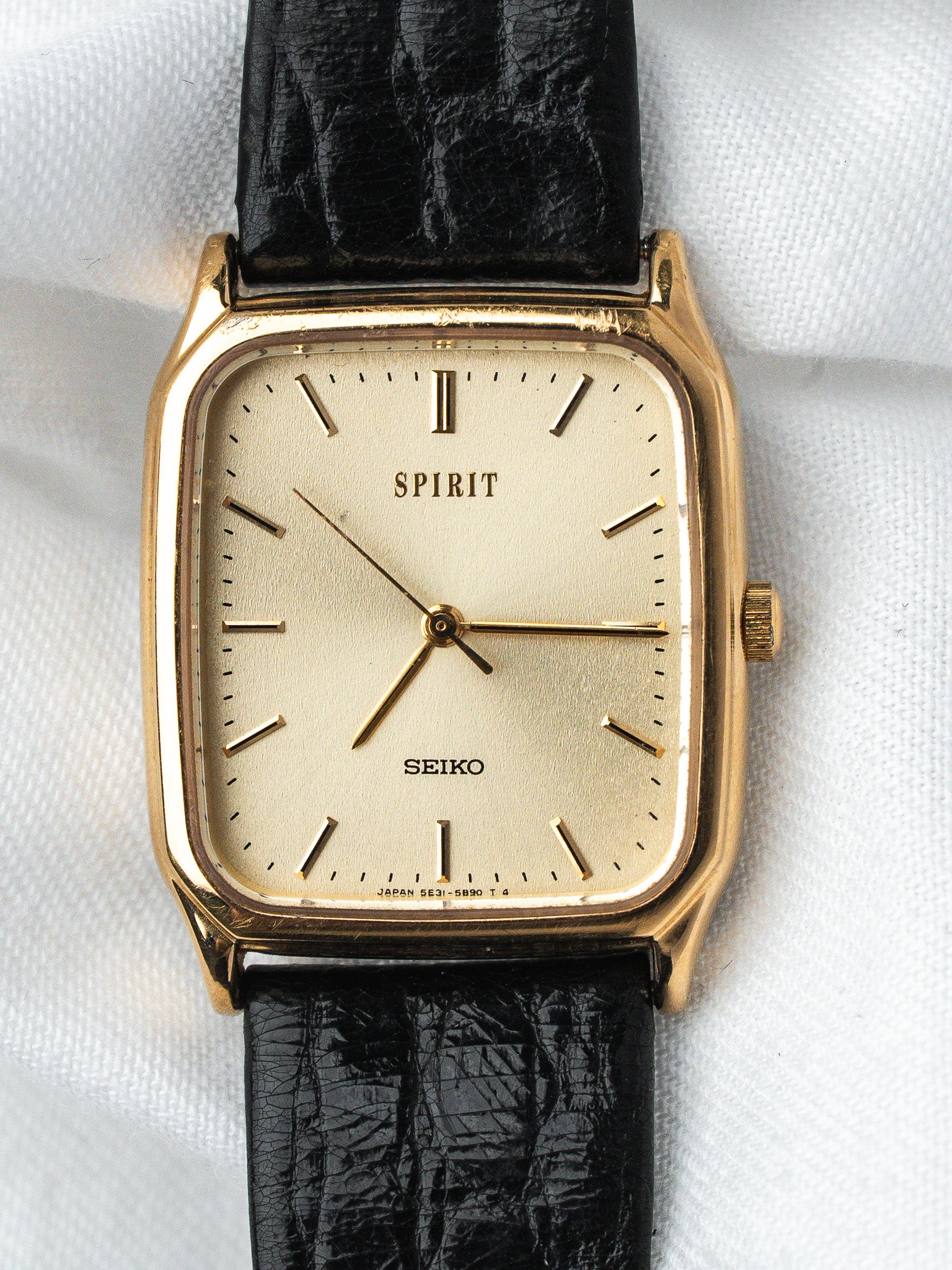 Seiko Spirit vintage watch with gold case, cream dial, black leather strap