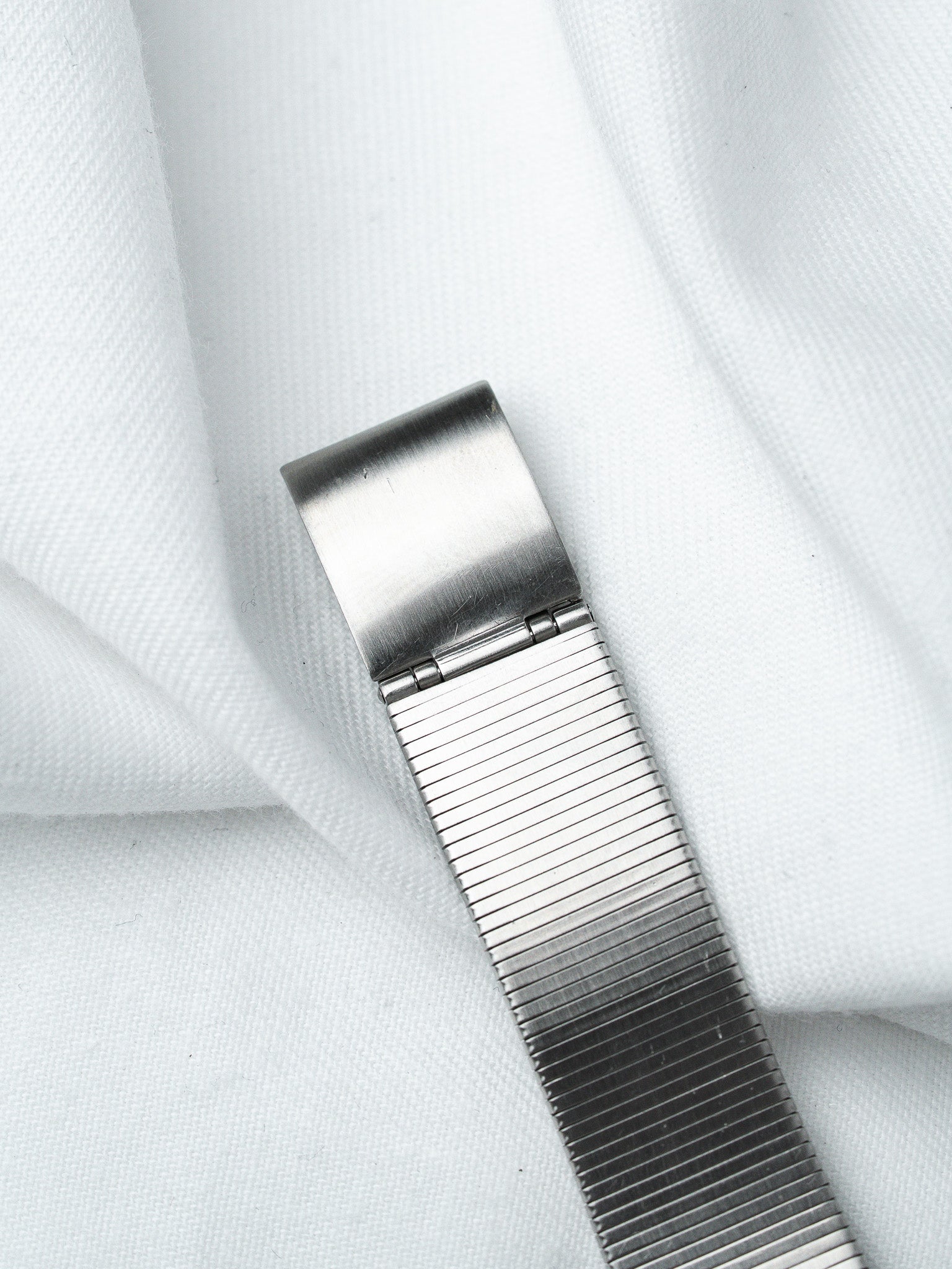 Vintage Rolex Oyster bracelet in stainless steel with brushed finish on white fabric