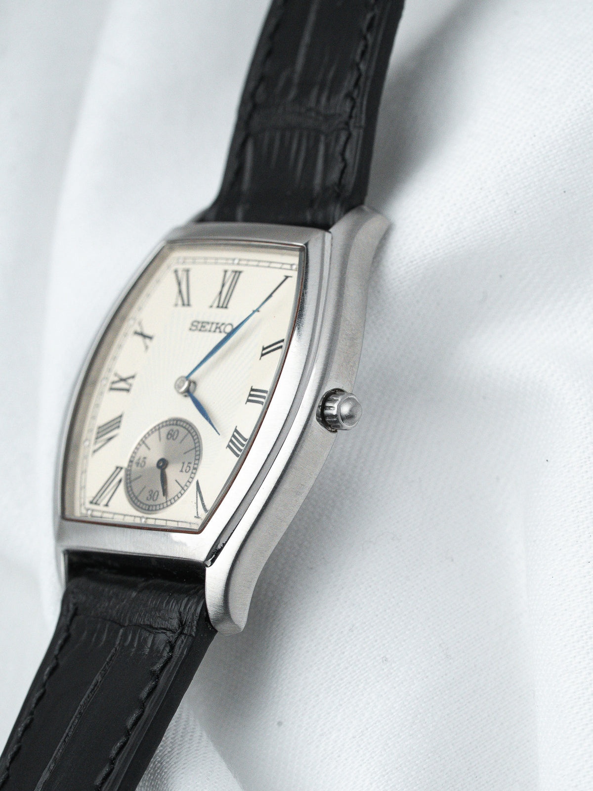 Seiko vintage watch with silver case, cream dial, Roman numerals, black leather strap