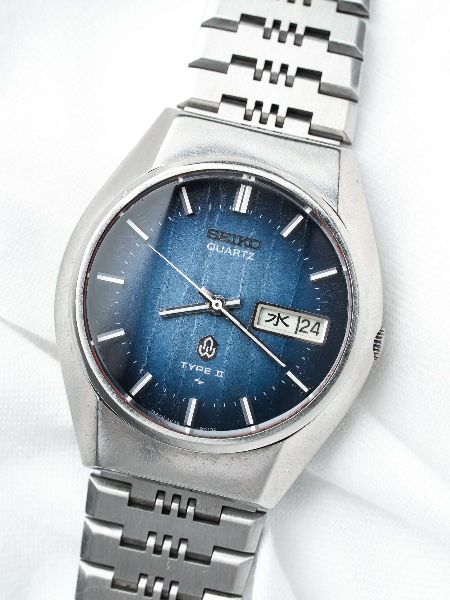 Seiko Quartz Type II vintage watch with blue dial and steel bracelet on white background