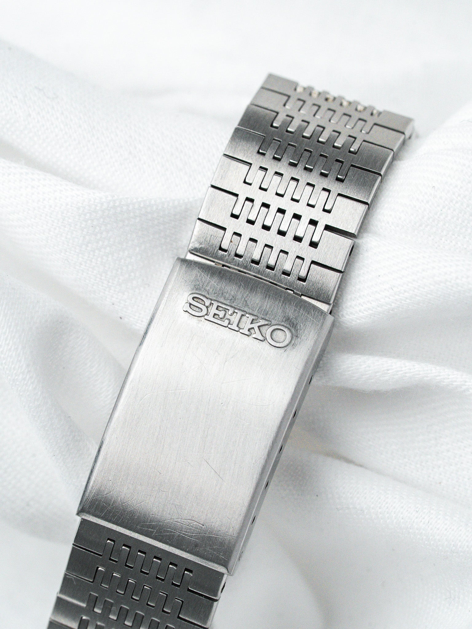 Seiko vintage watch bracelet with textured steel links and engraved clasp