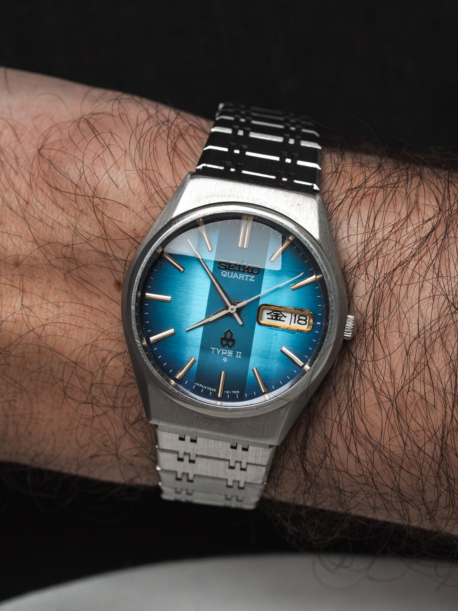 Seiko Quartz Type II vintage watch with blue dial and steel bracelet worn on wrist