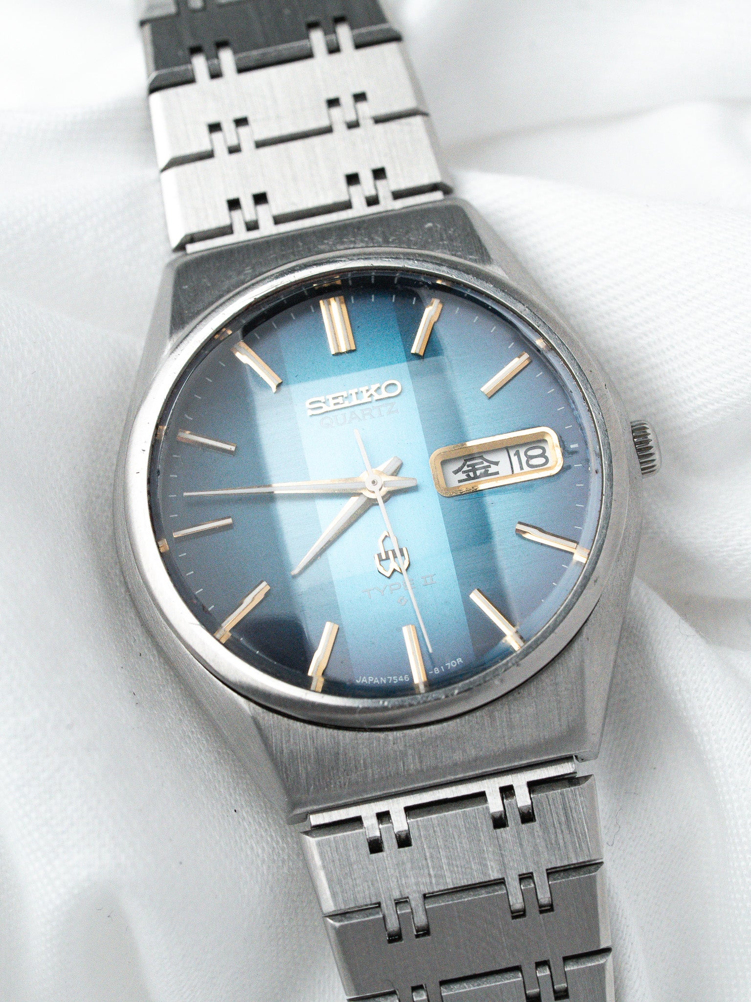 Seiko vintage quartz watch with blue gradient dial and steel bracelet