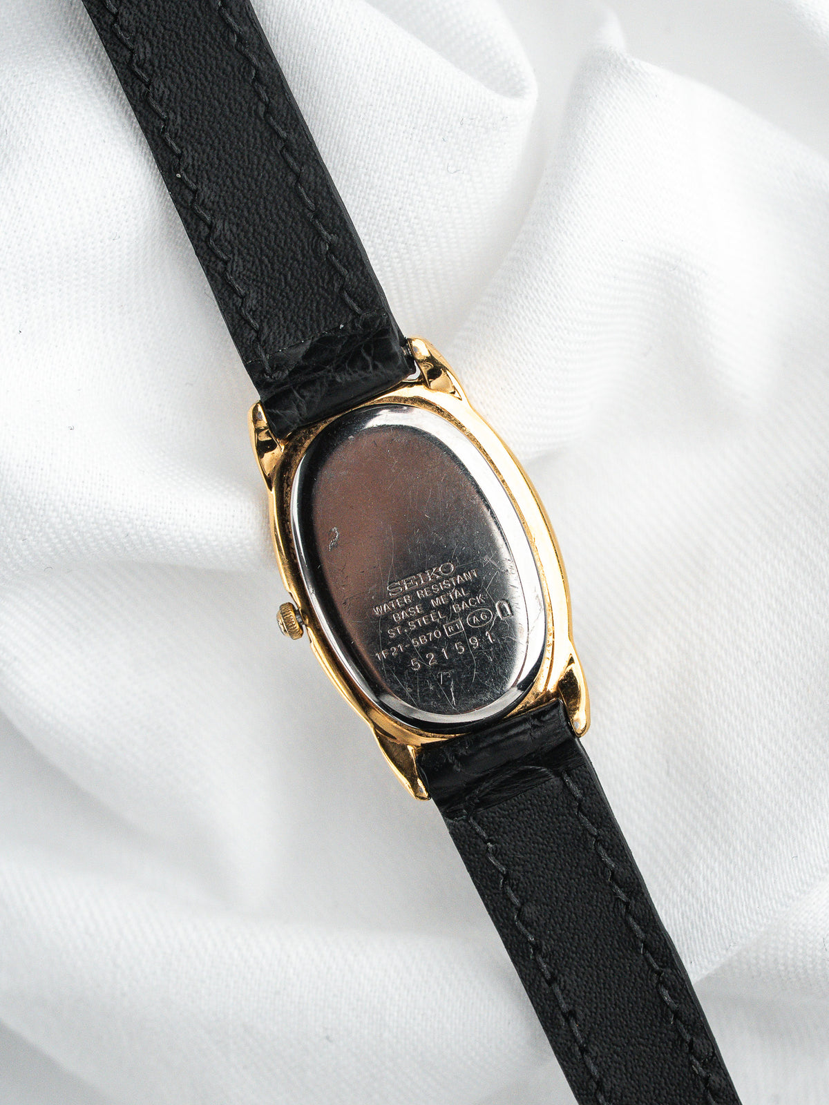 Montre Seiko vintage, boîtier ovale plaqué or et bracelet en cuir noir