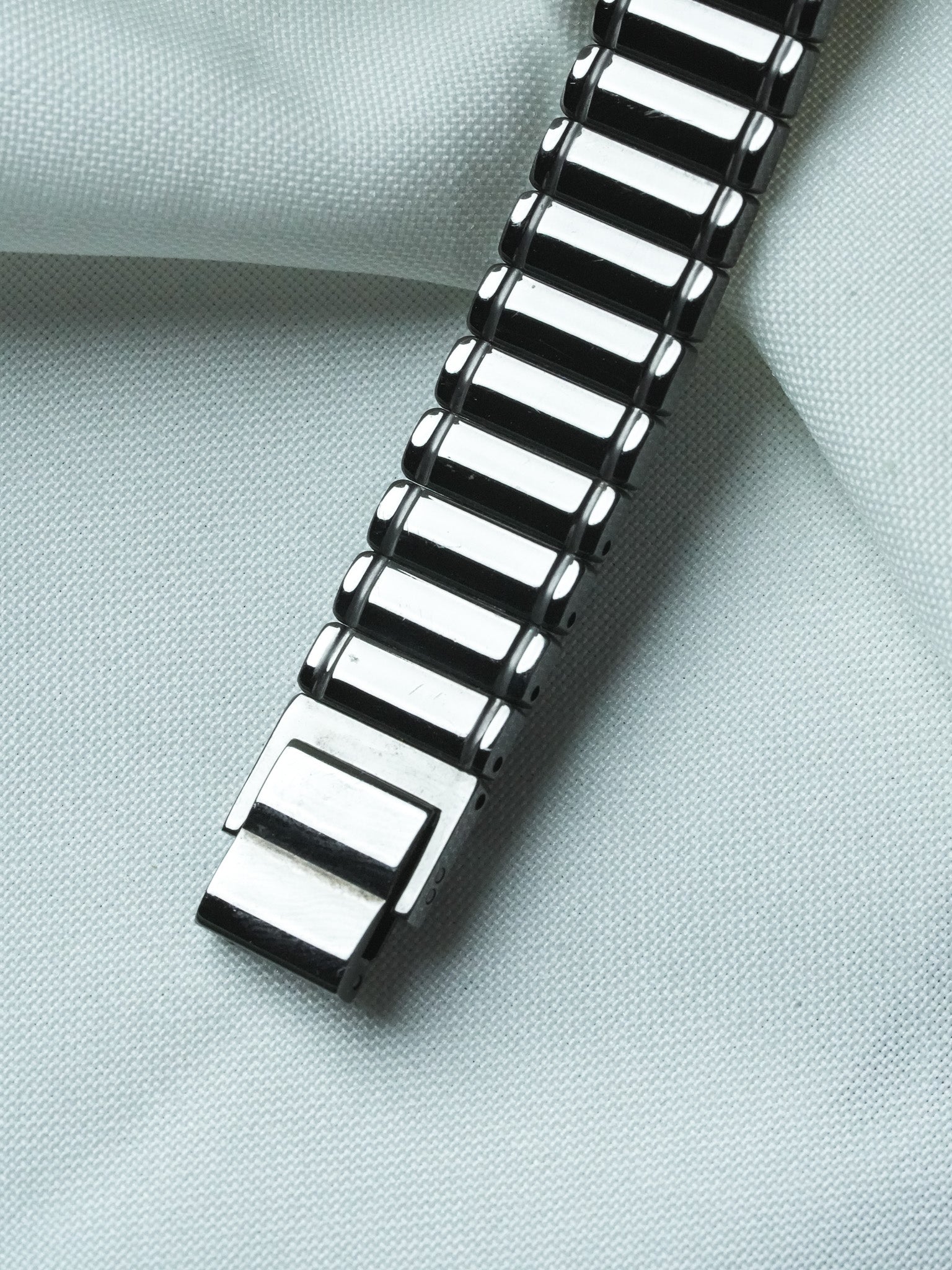 Vintage Cartier watch bracelet with black and white enamel links on fabric