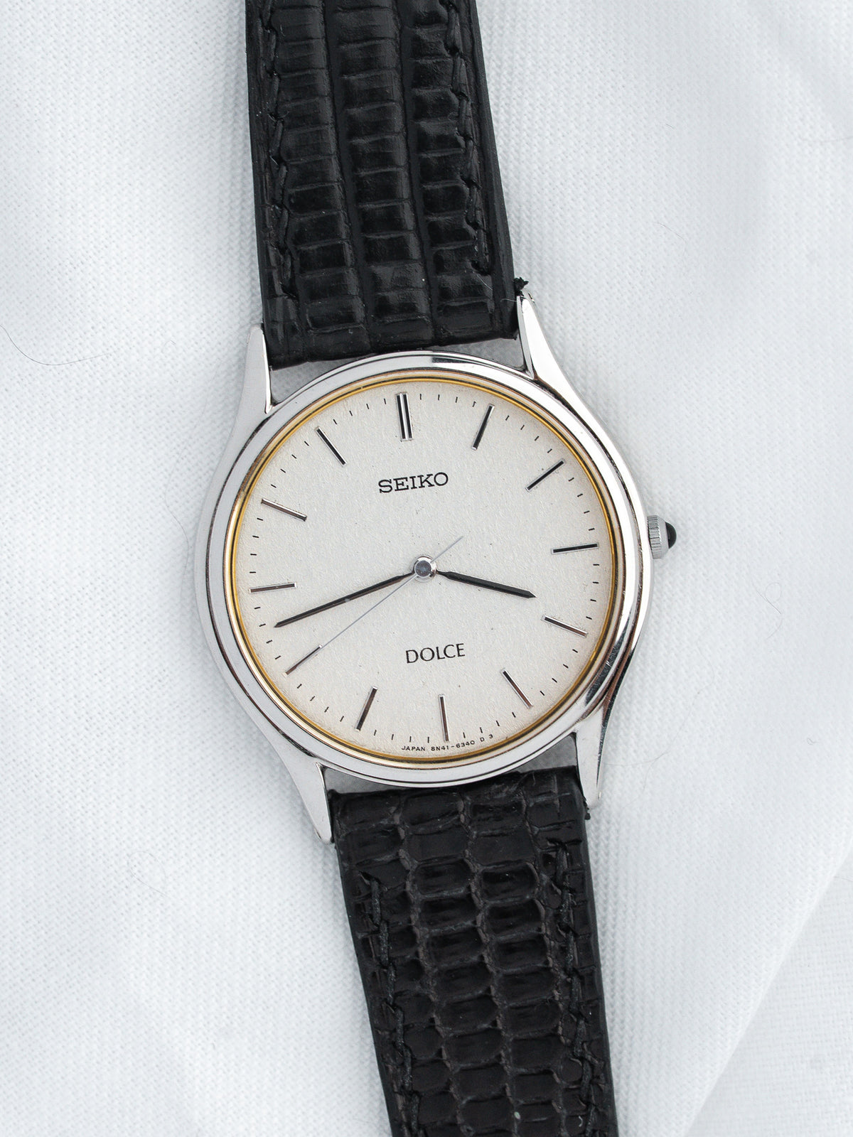 Seiko Dolce vintage watch with white dial, gold accents, black textured strap