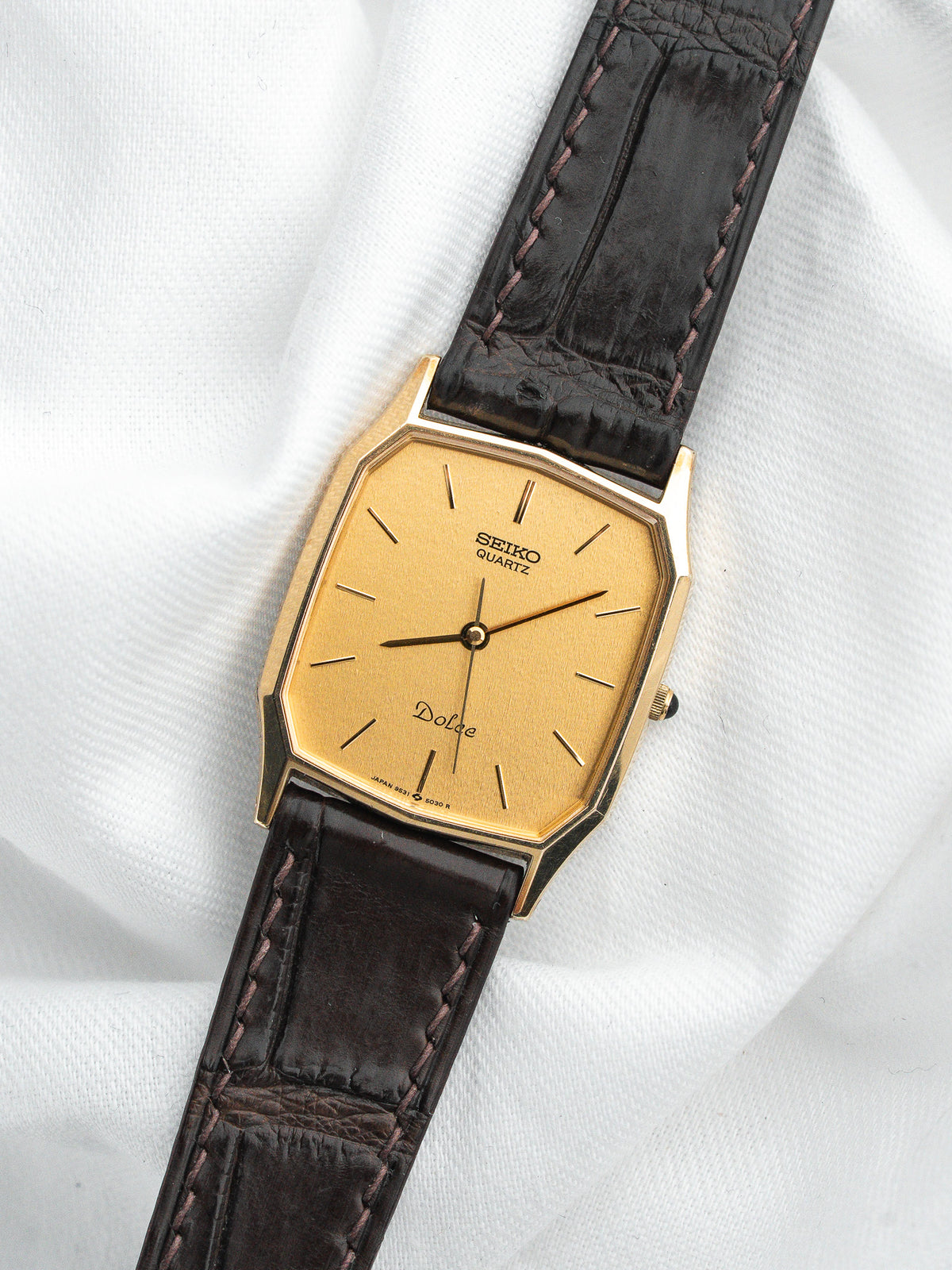 Montre Seiko Dolce vintage, boîtier rectangulaire doré, cadran or et bracelet cuir marron