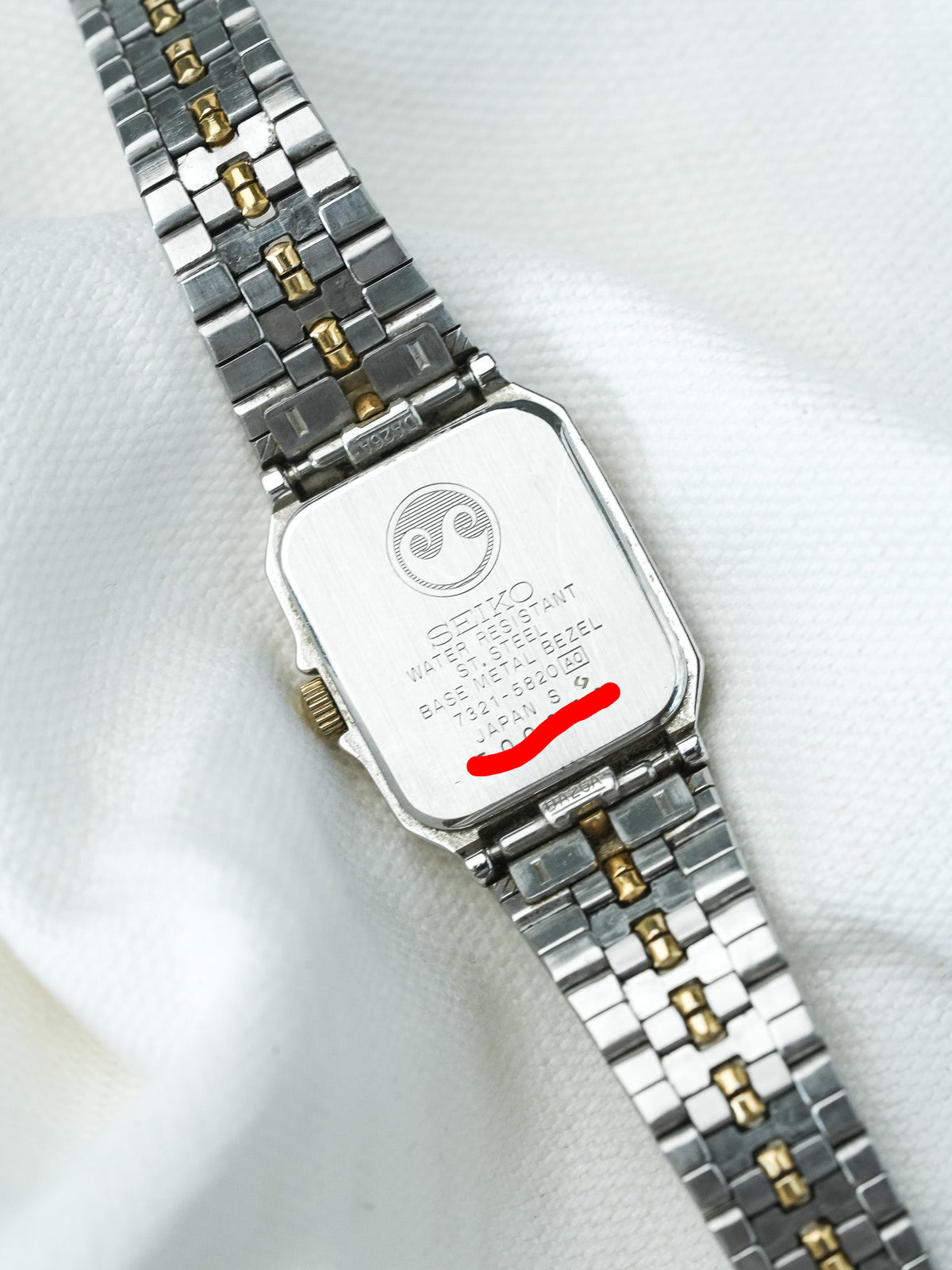 Seiko vintage watch with two-tone bracelet, stainless steel case back, and engraved details