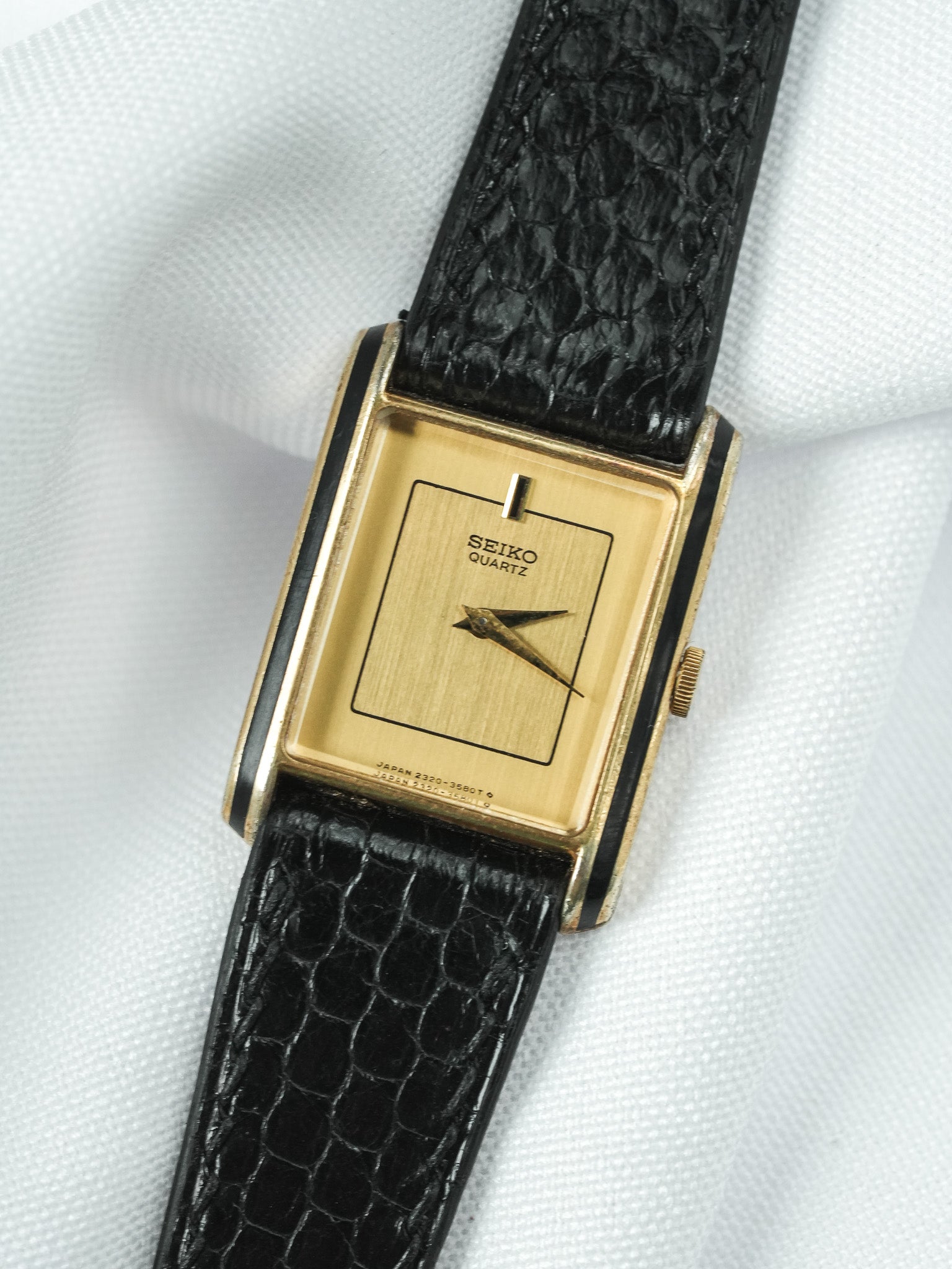Seiko Quartz vintage watch with gold rectangular case and black crocodile strap
