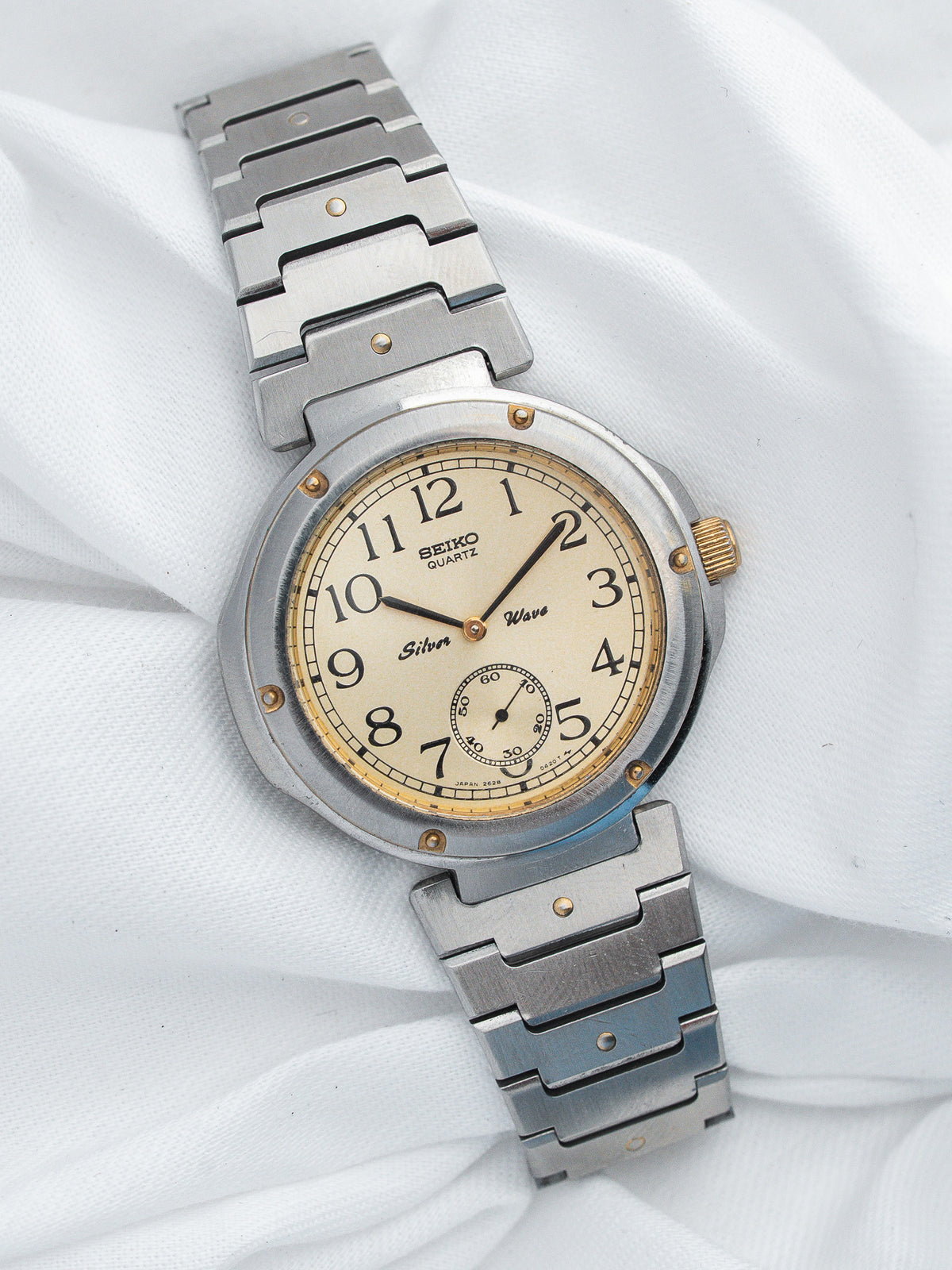 Seiko Quartz vintage watch with cream dial, steel bracelet, and gold accents