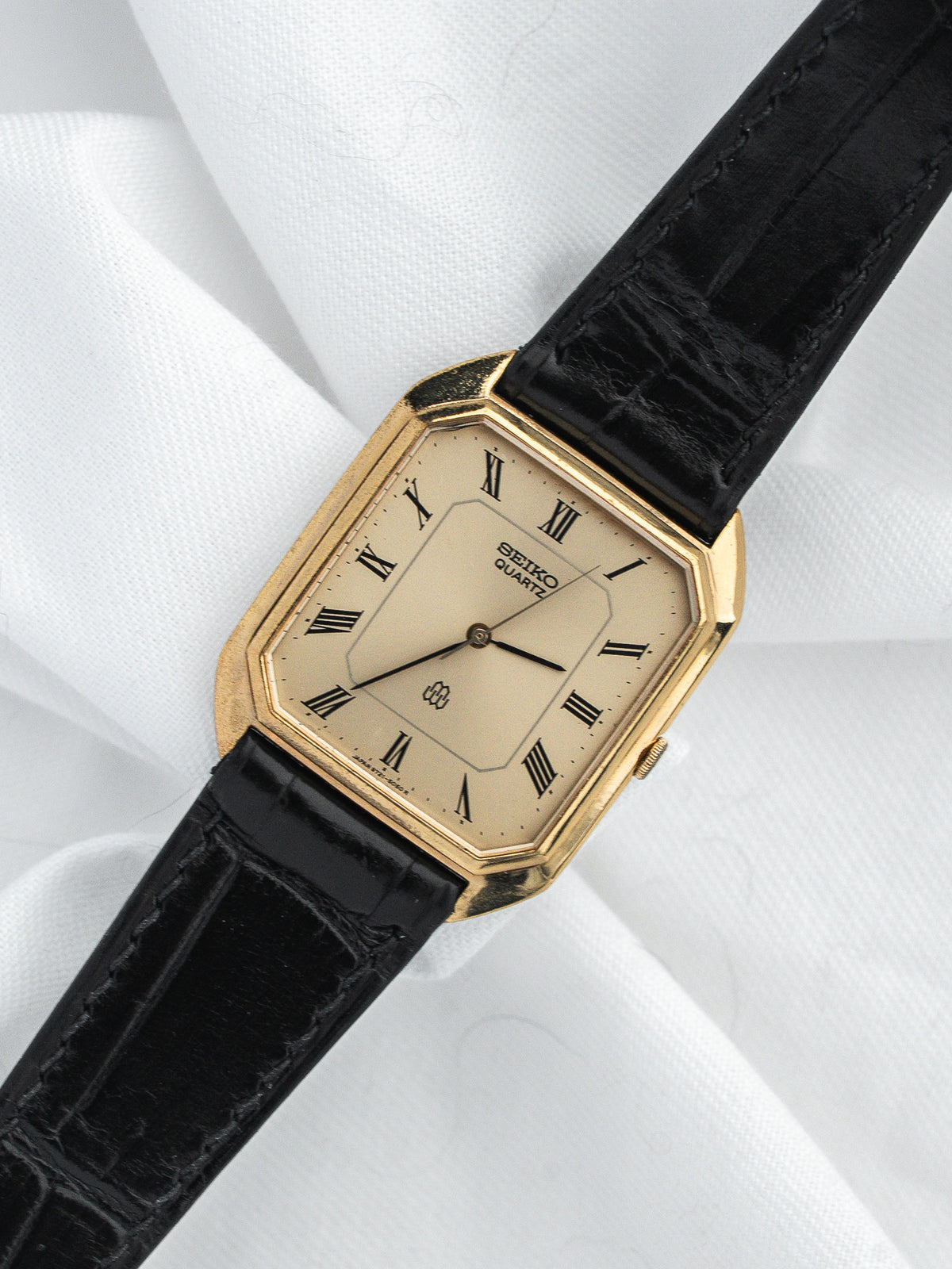Seiko Quartz vintage watch with gold case, cream dial, Roman numerals, black leather strap