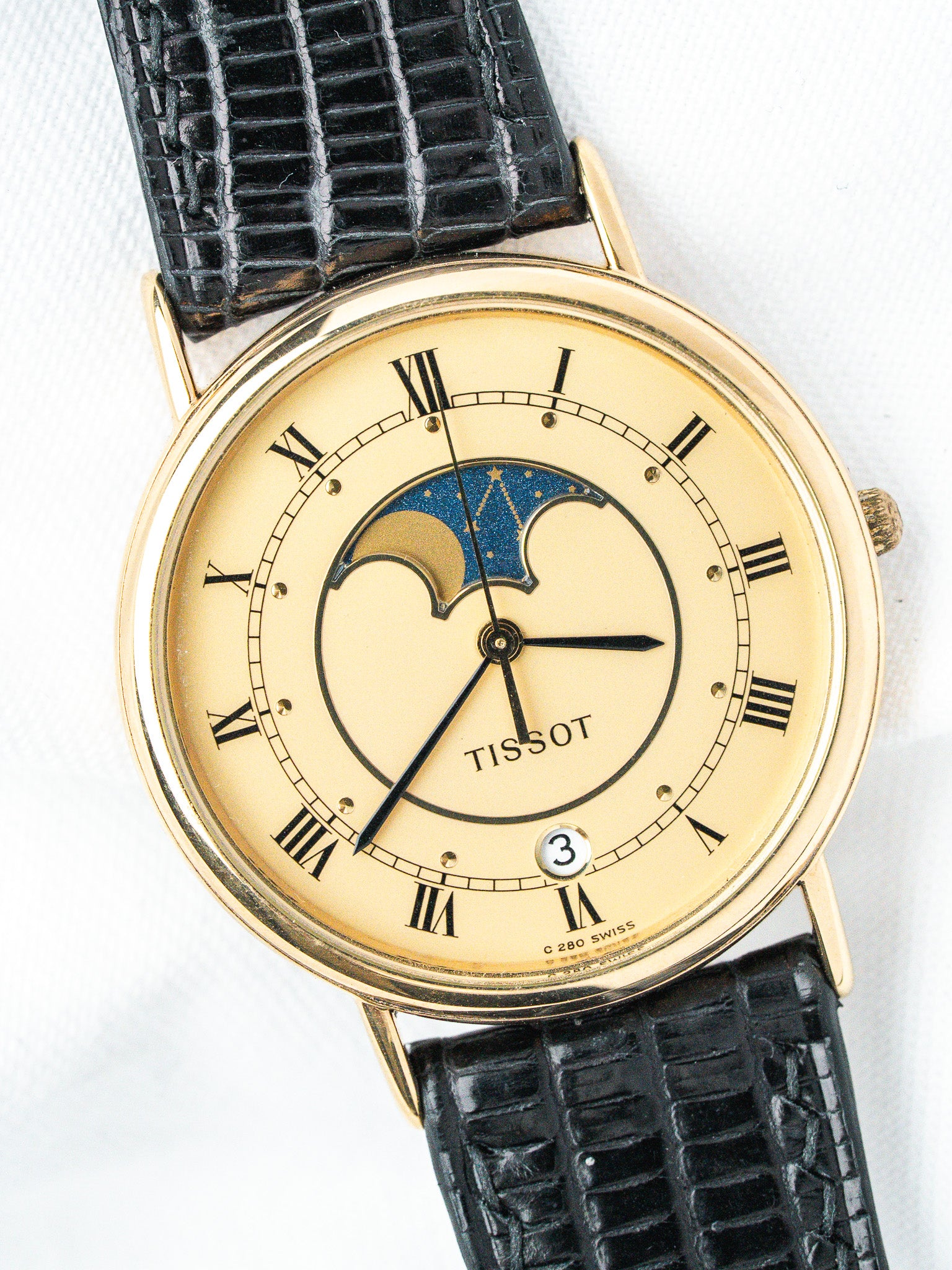 Tissot vintage watch with gold case, cream dial, moon phase, black alligator strap