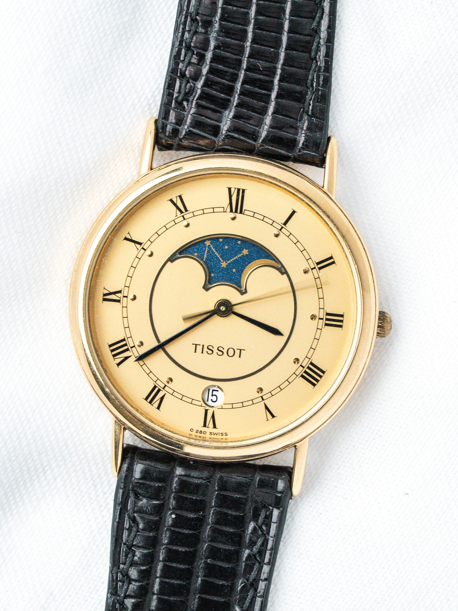Tissot vintage watch with gold case, cream dial, moon phase, black alligator strap