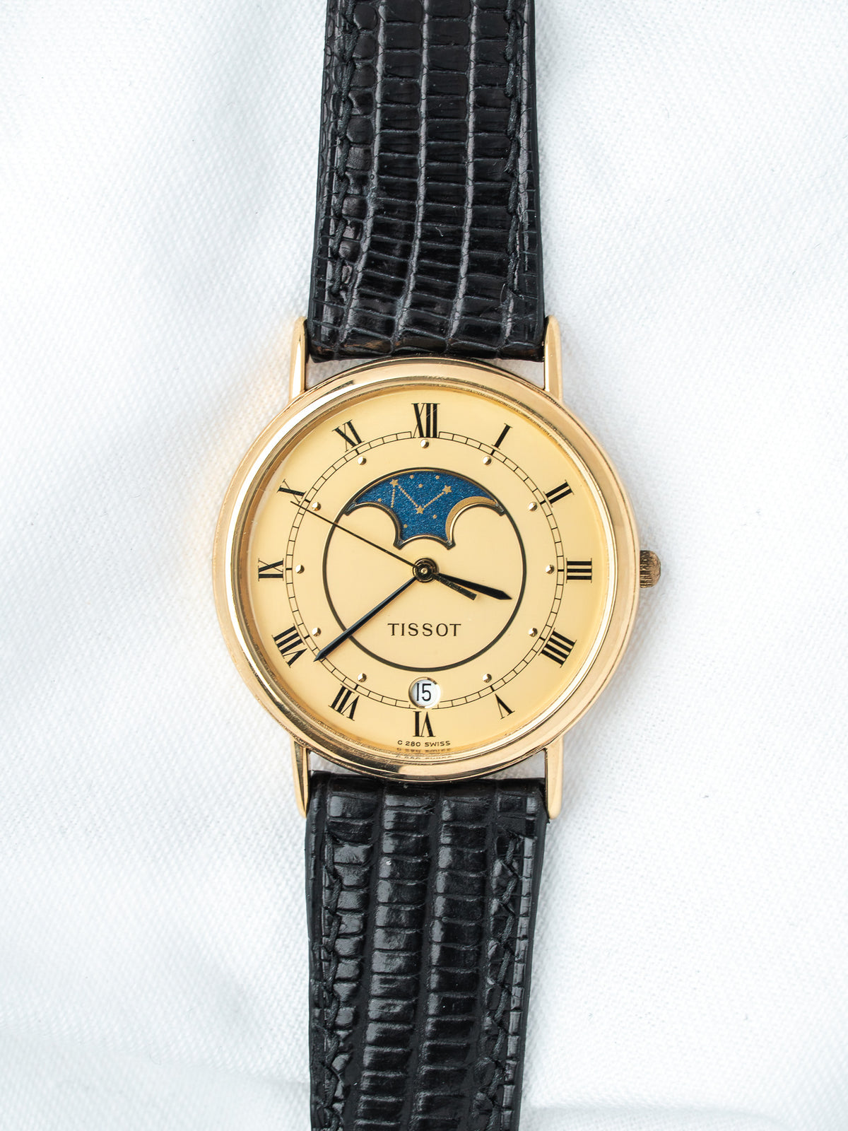Tissot vintage watch with gold case, cream dial, moon phase, black leather strap