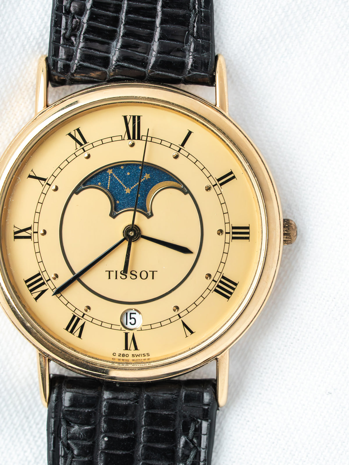 Tissot vintage watch with gold case, cream dial, moon phase, black alligator strap