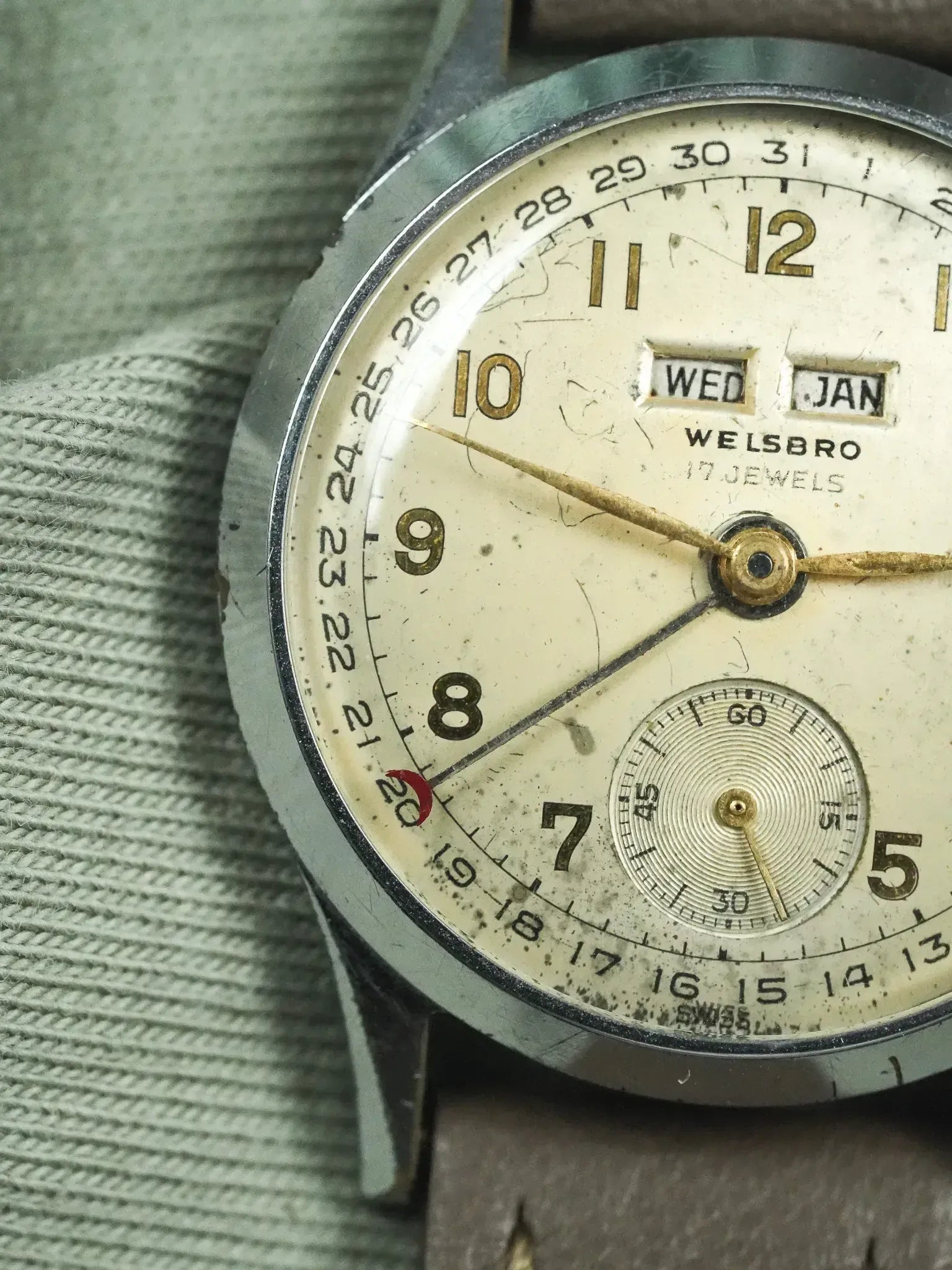 Vintage Welsbro watch with cream dial, day-date windows, and brown leather strap