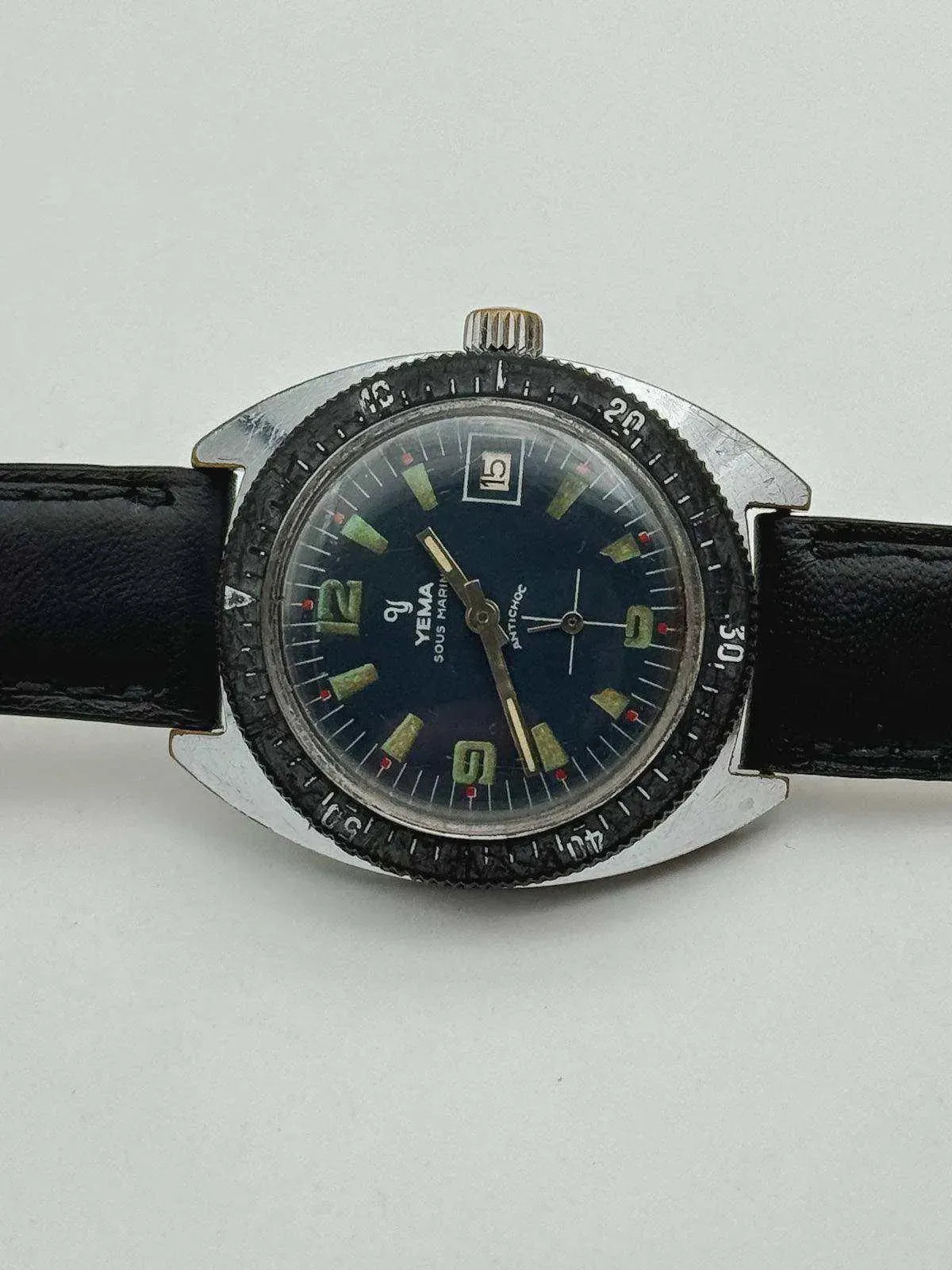Yema Sous Marin vintage watch with black dial, green markers, and black leather strap