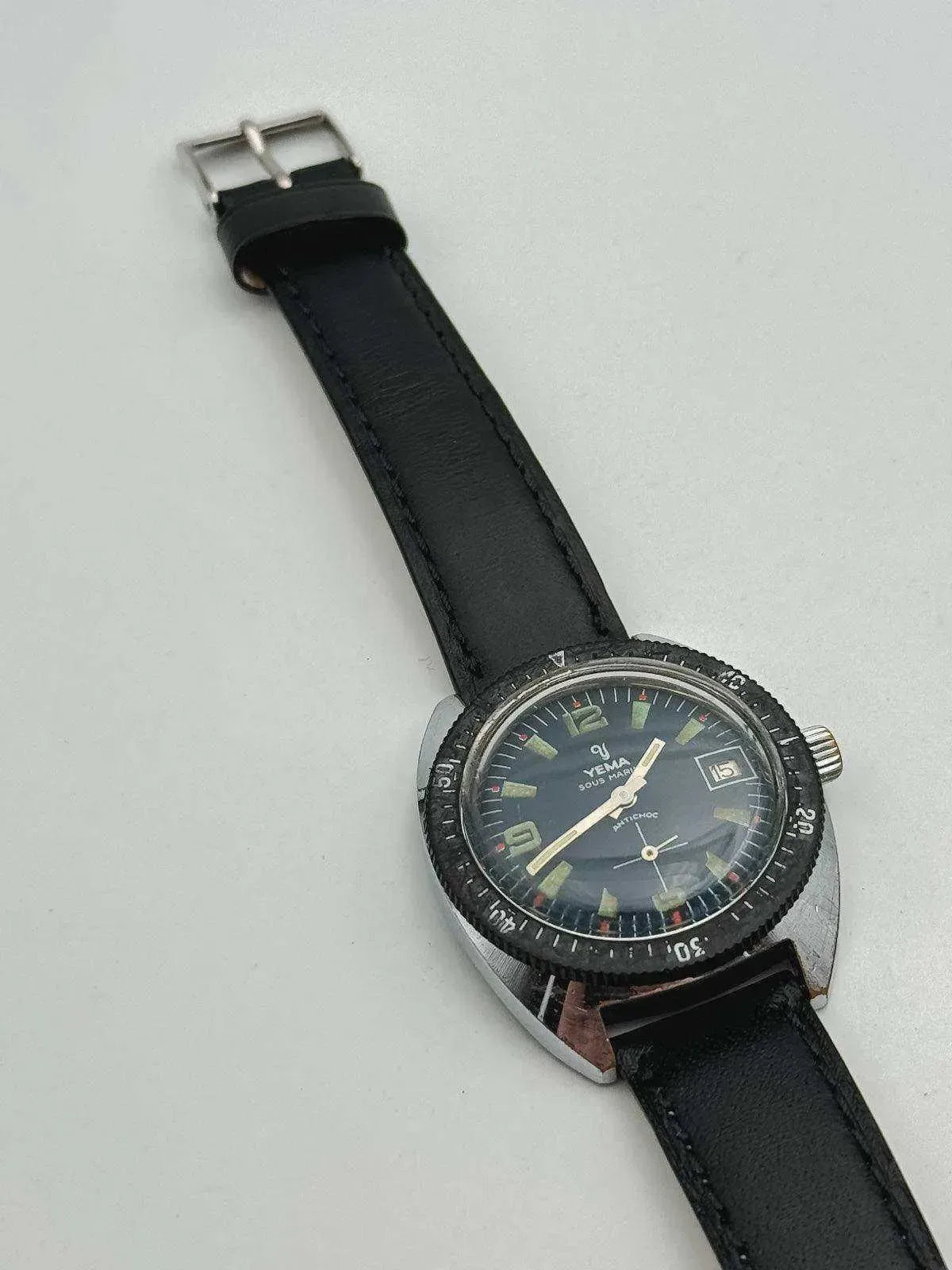 Yema Sous Marine vintage watch with black dial, luminous markers, and black leather strap