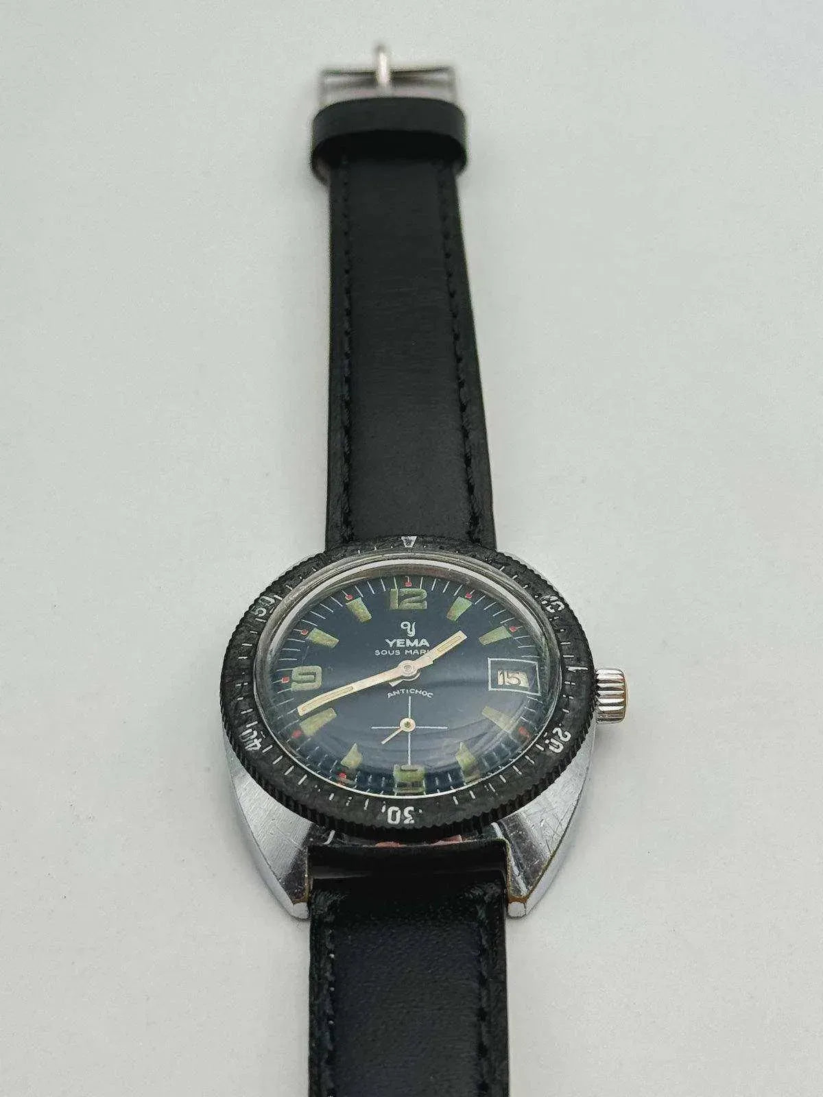 Yema Sous Marine vintage watch with black dial, luminous markers, and black leather strap