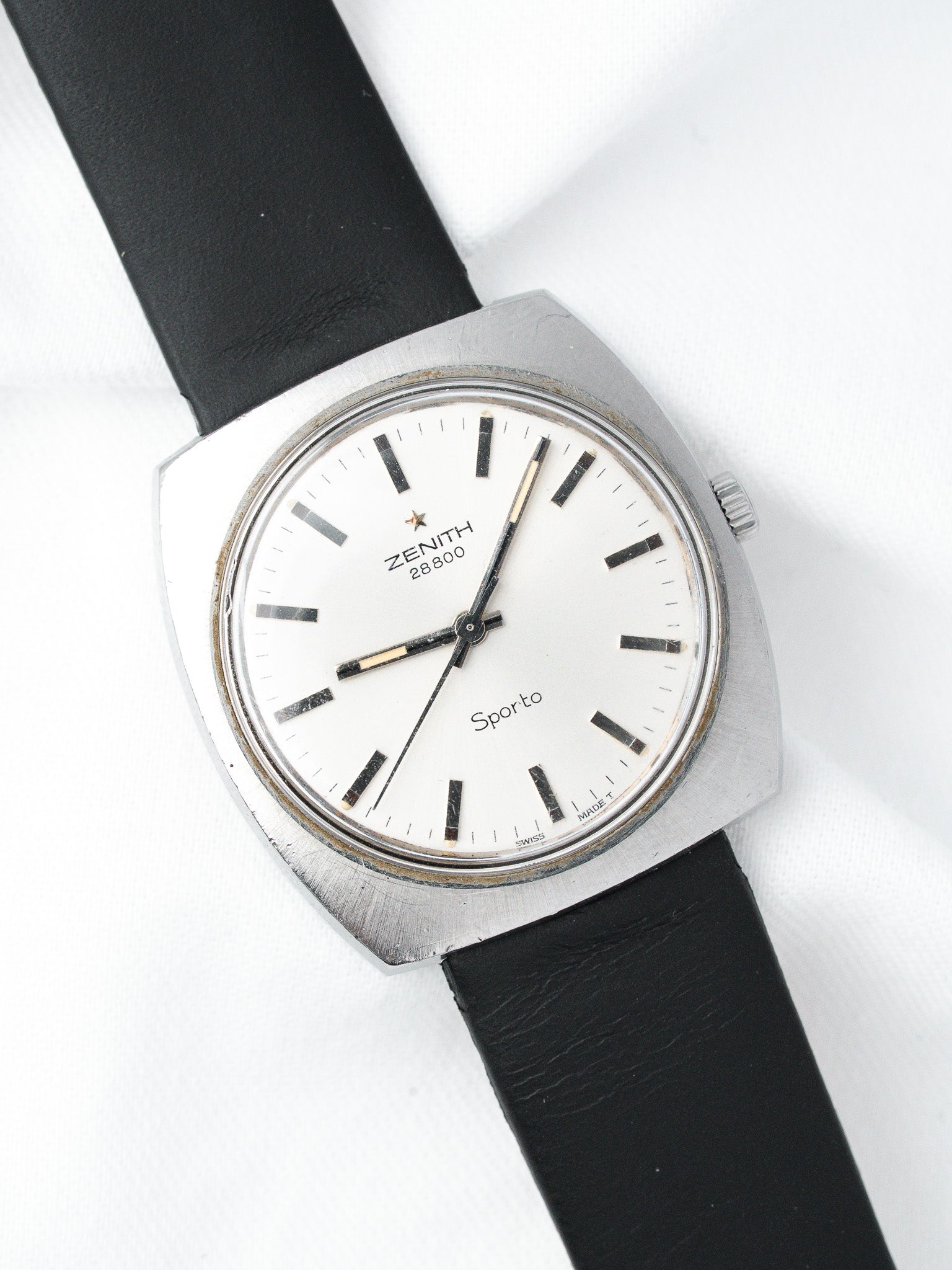 Zenith Sporto vintage watch with white dial, black leather strap, and steel case