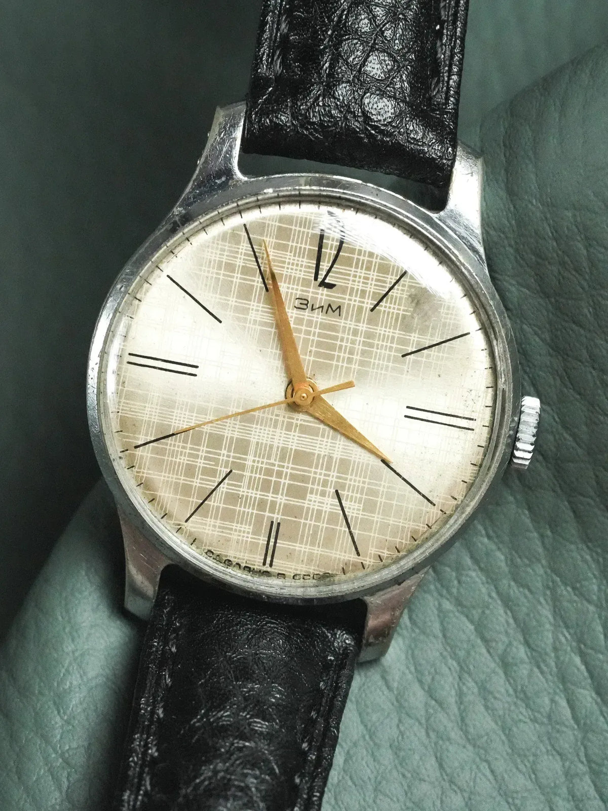 Vintage ZIM watch with silver case, grid dial, gold hands, black leather strap