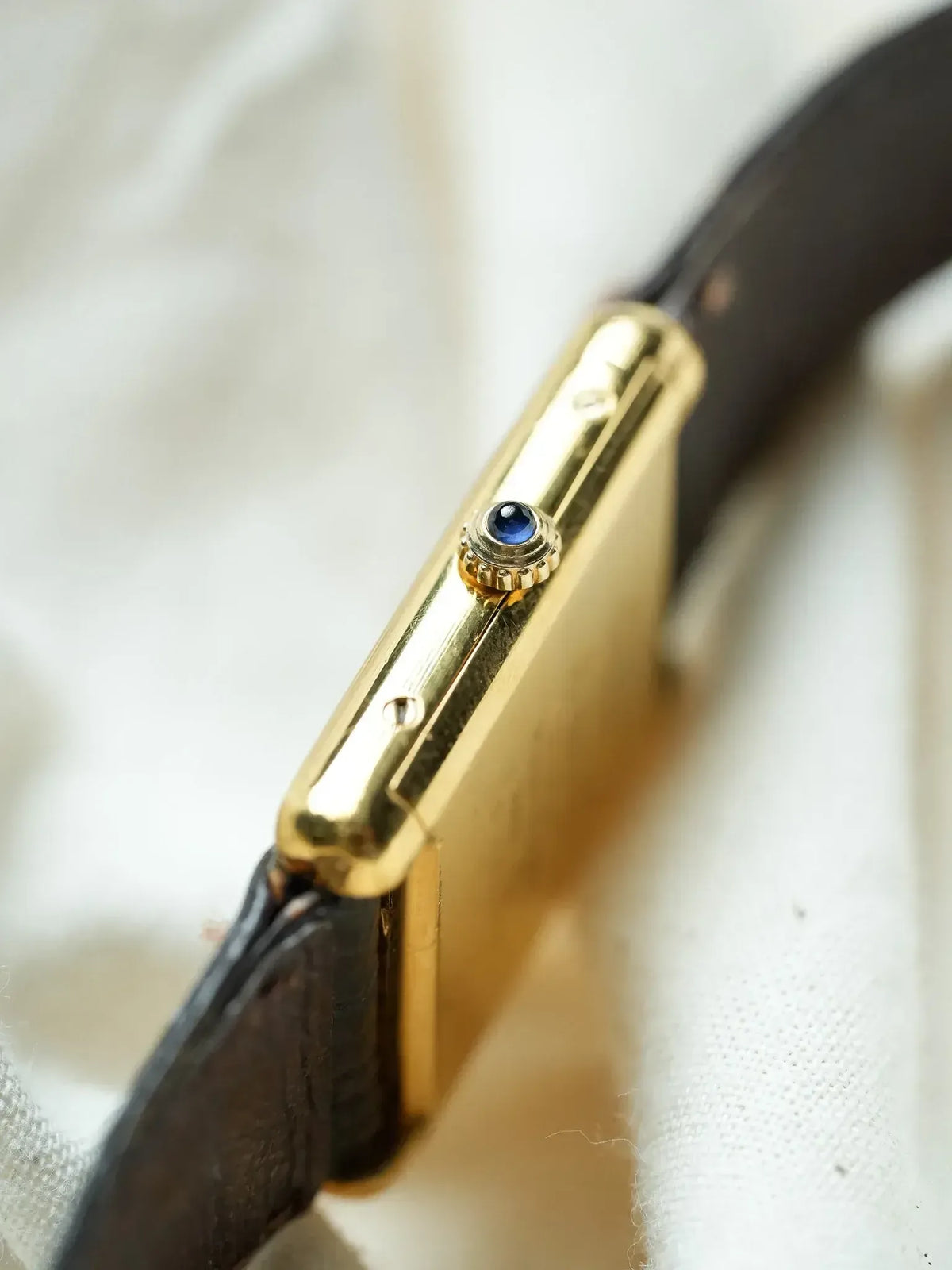 Cartier Tank vintage gold case with blue sapphire crown, black leather strap
