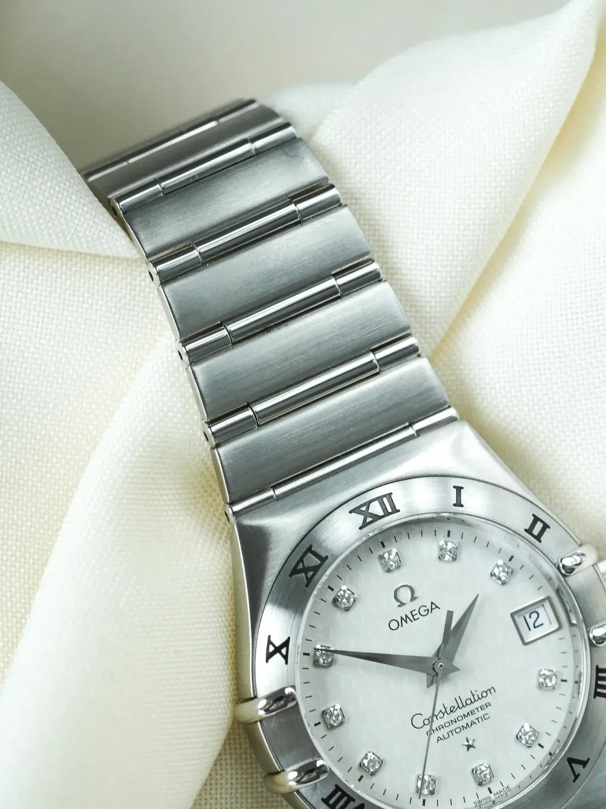 Omega Constellation vintage watch with diamond hour markers and stainless steel bracelet