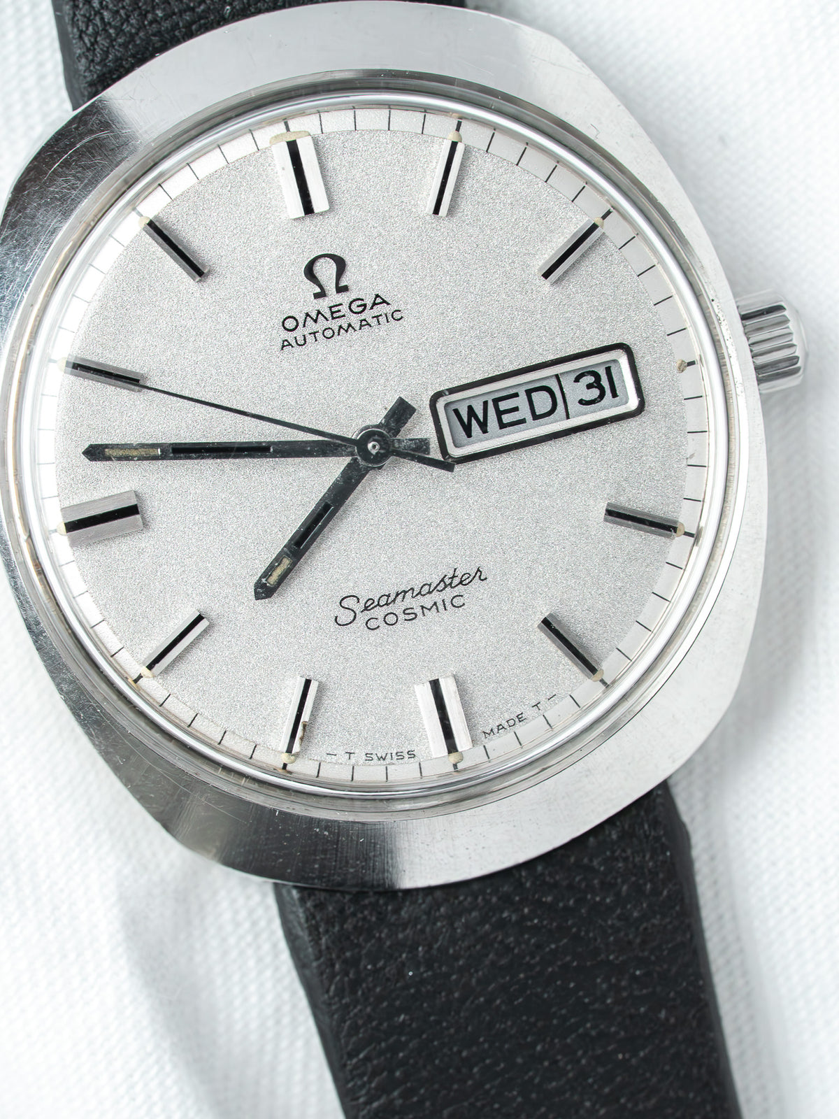 Omega Seamaster Cosmic vintage watch with silver dial, day-date window, black leather strap