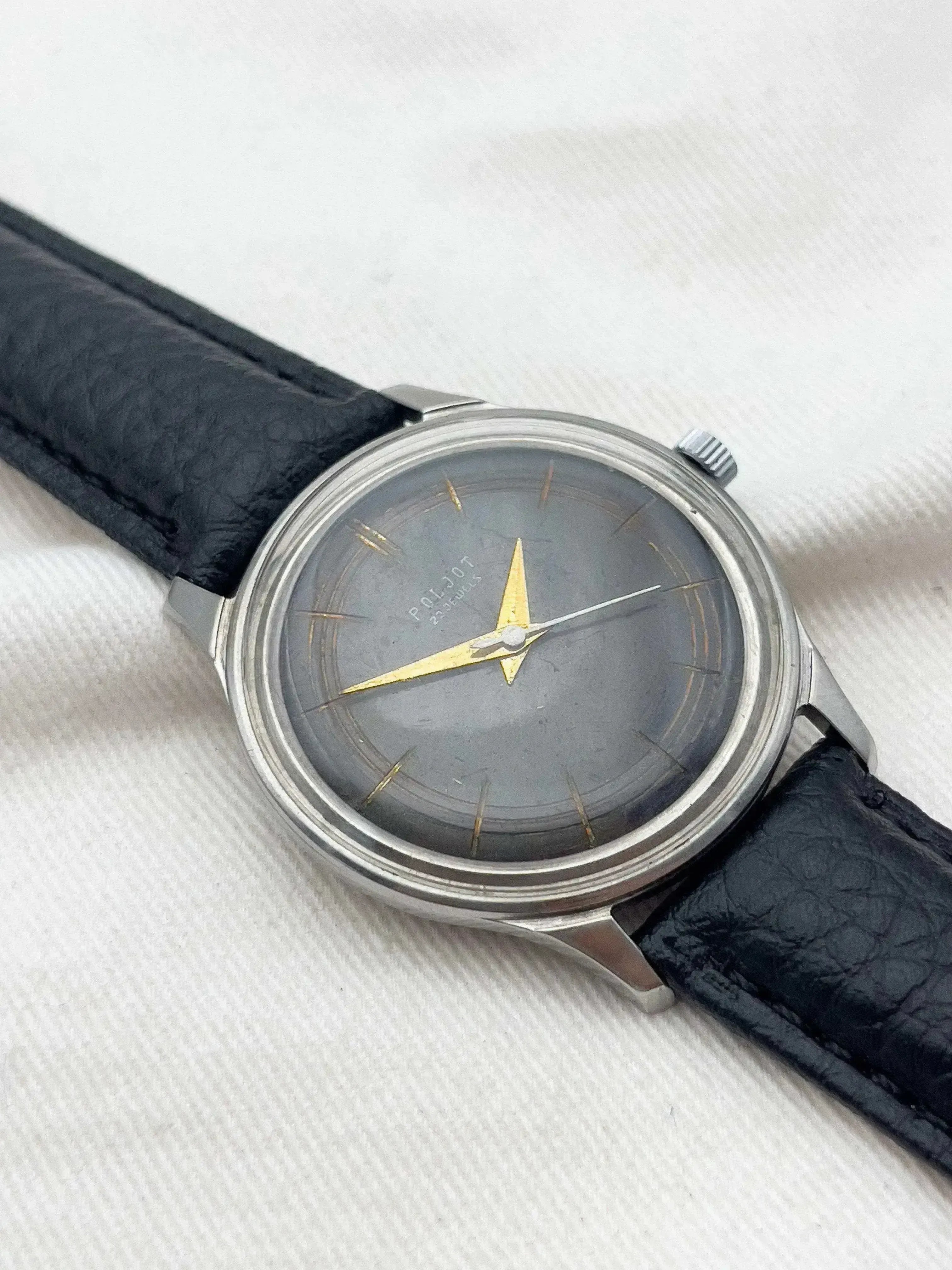 Poljot vintage watch with grey dial, gold hands, and black leather strap