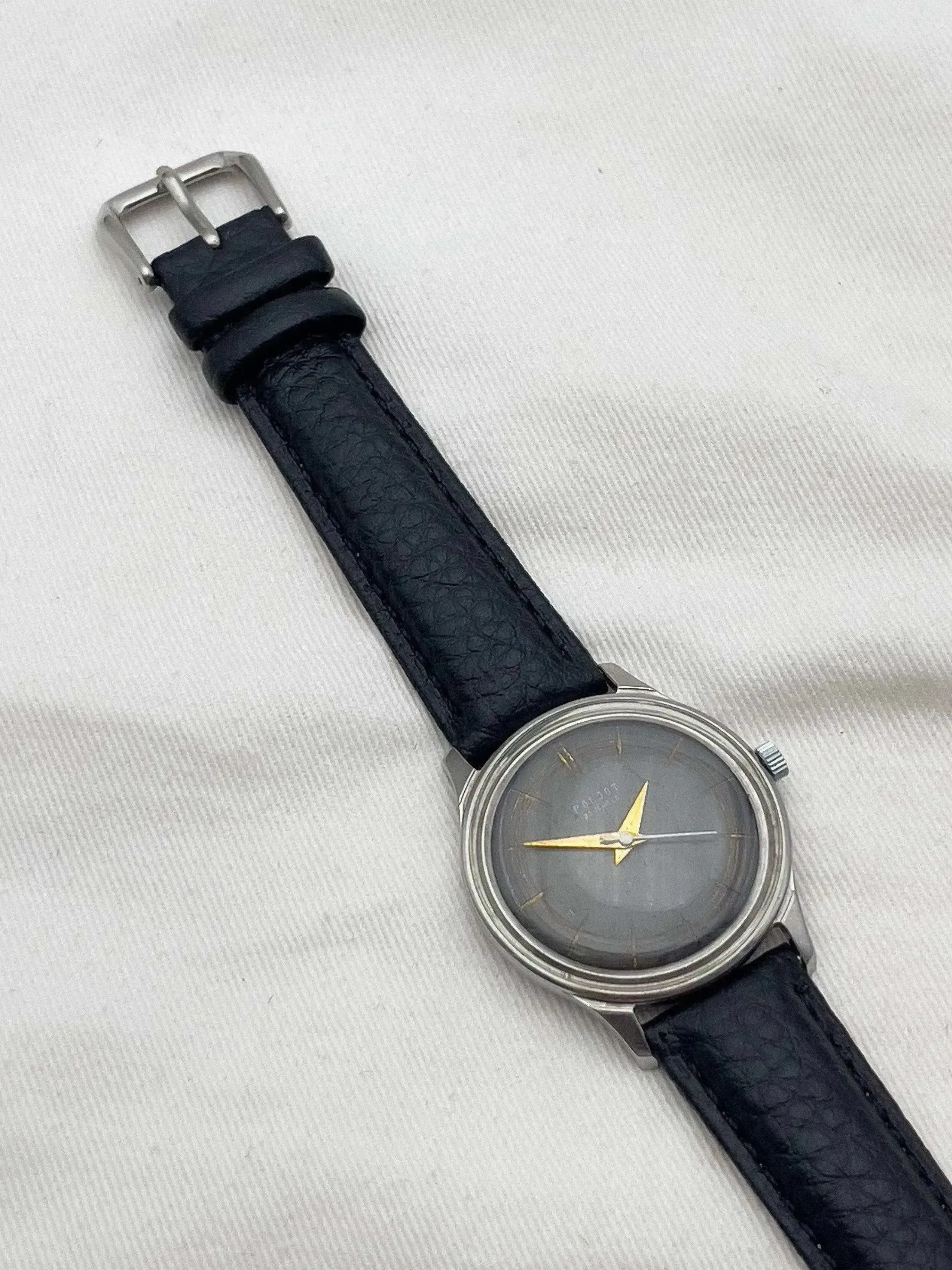 Poljot vintage watch with grey dial, gold hands, black leather strap on white background