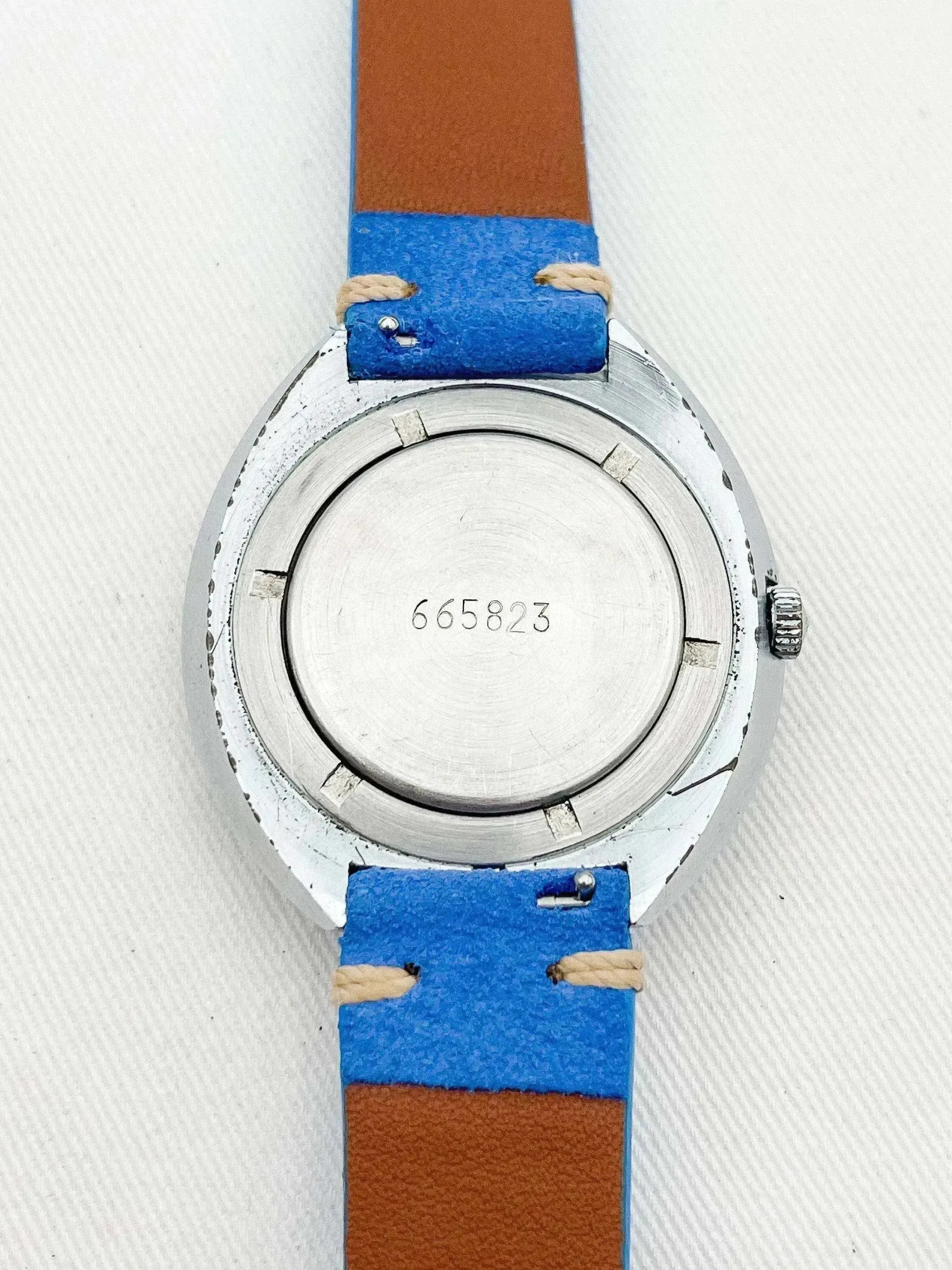Vintage watch with blue and brown strap, silver case back, engraved number 665823