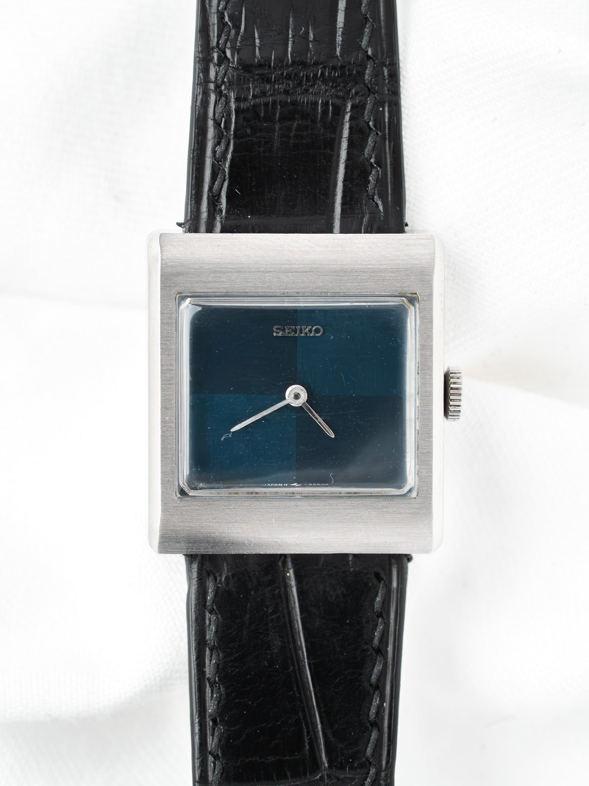 Seiko vintage watch with square silver case, blue dial, black leather strap