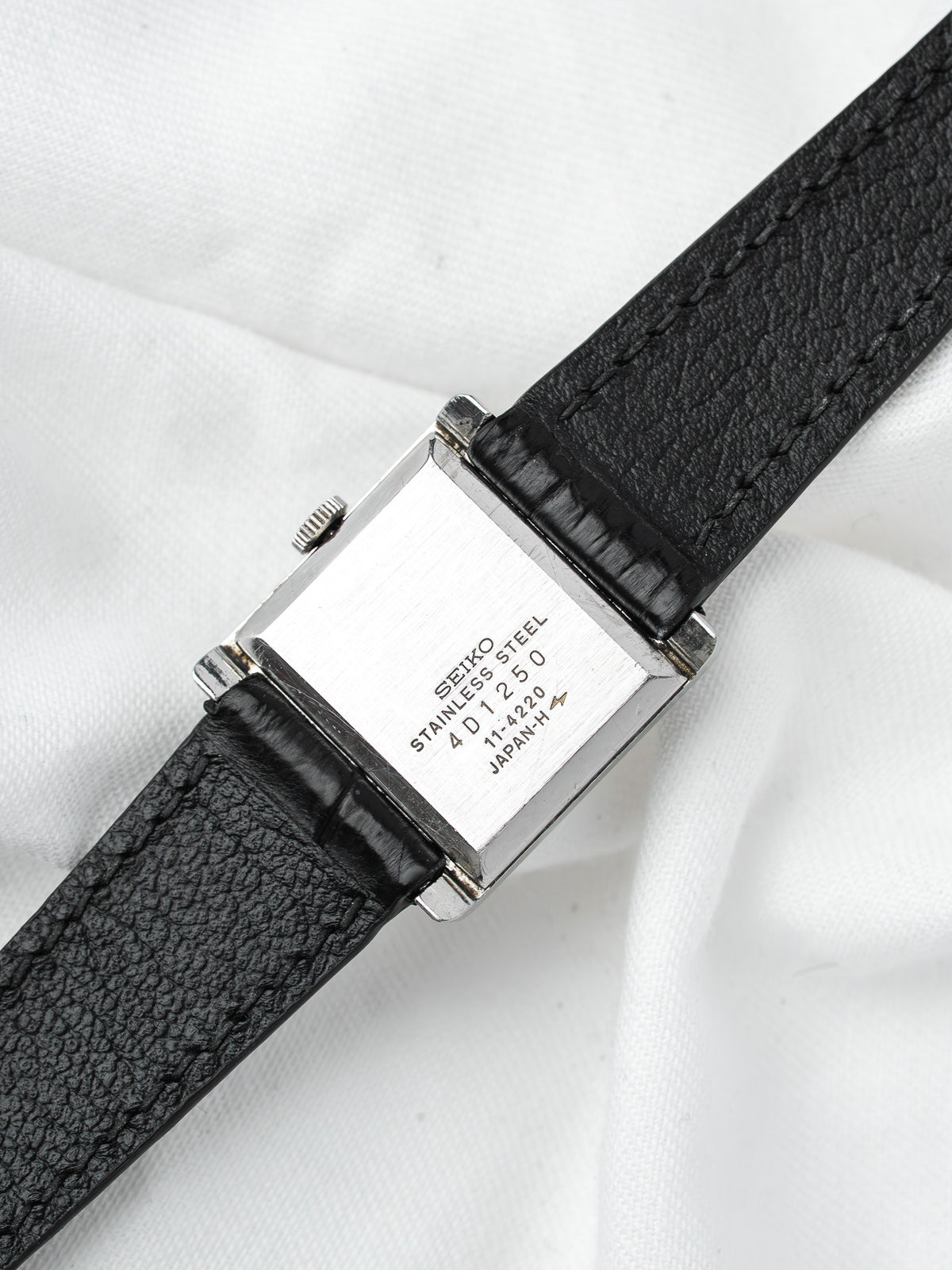 Seiko vintage watch with stainless steel case and black leather strap