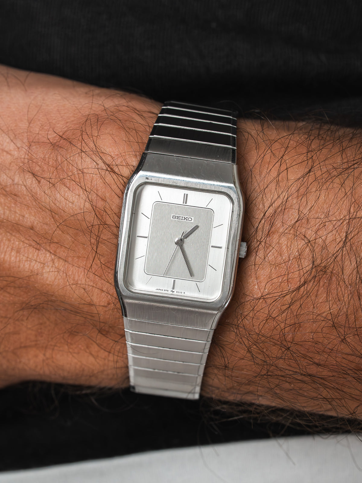 Seiko vintage watch with silver dial and steel bracelet worn on wrist