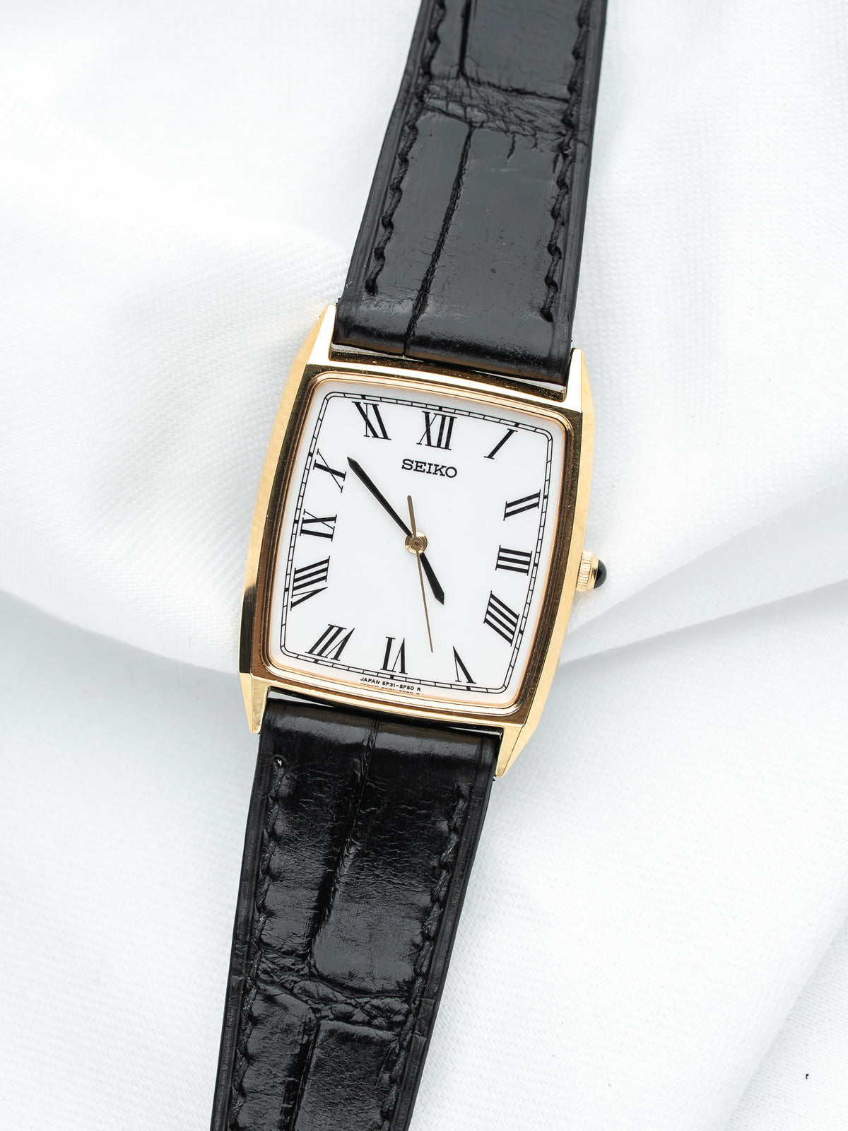 Seiko vintage watch with gold case, white dial, black leather strap