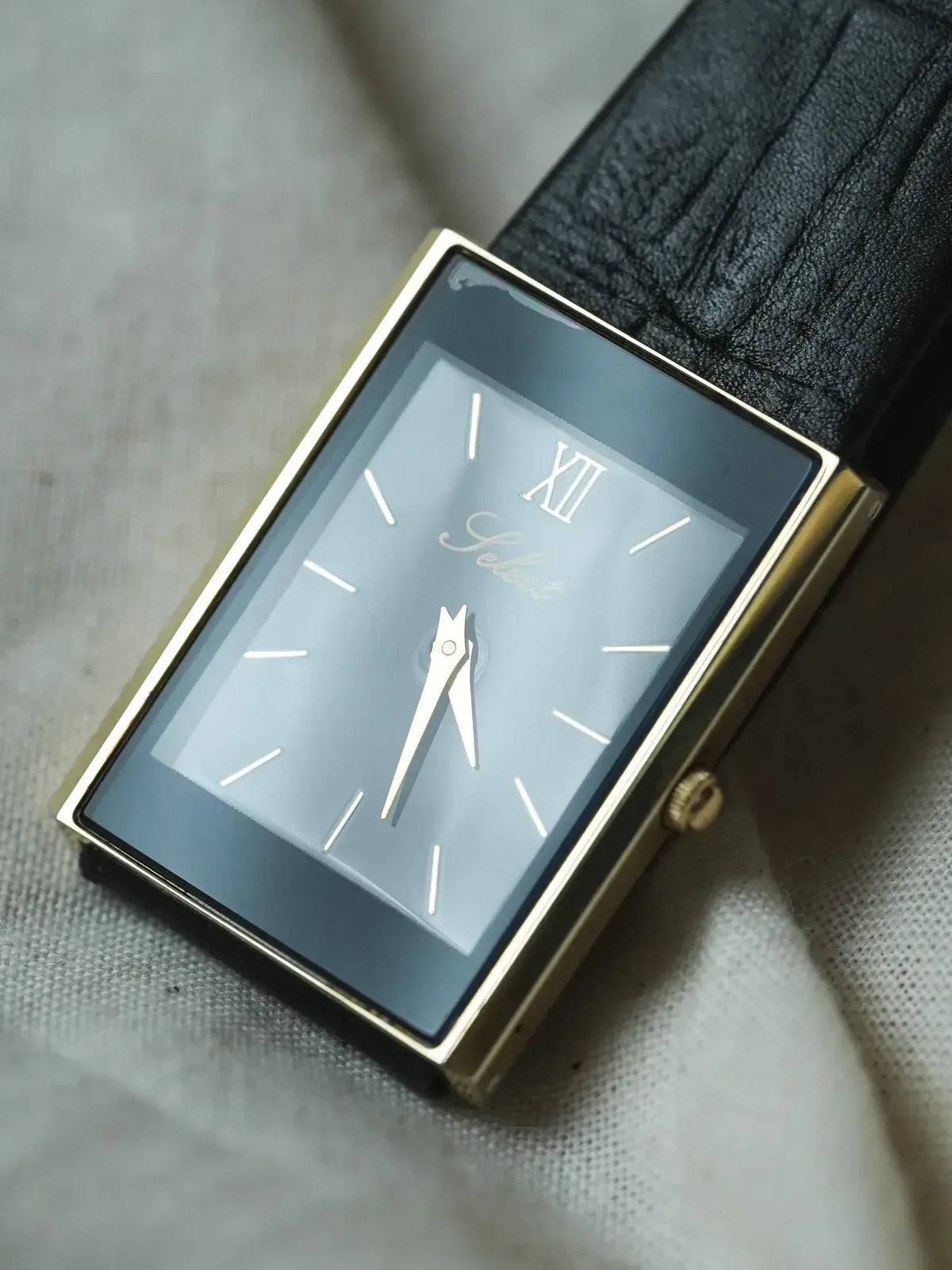 Vintage Solvil et Titus rectangular watch with gold case, grey dial, black leather strap