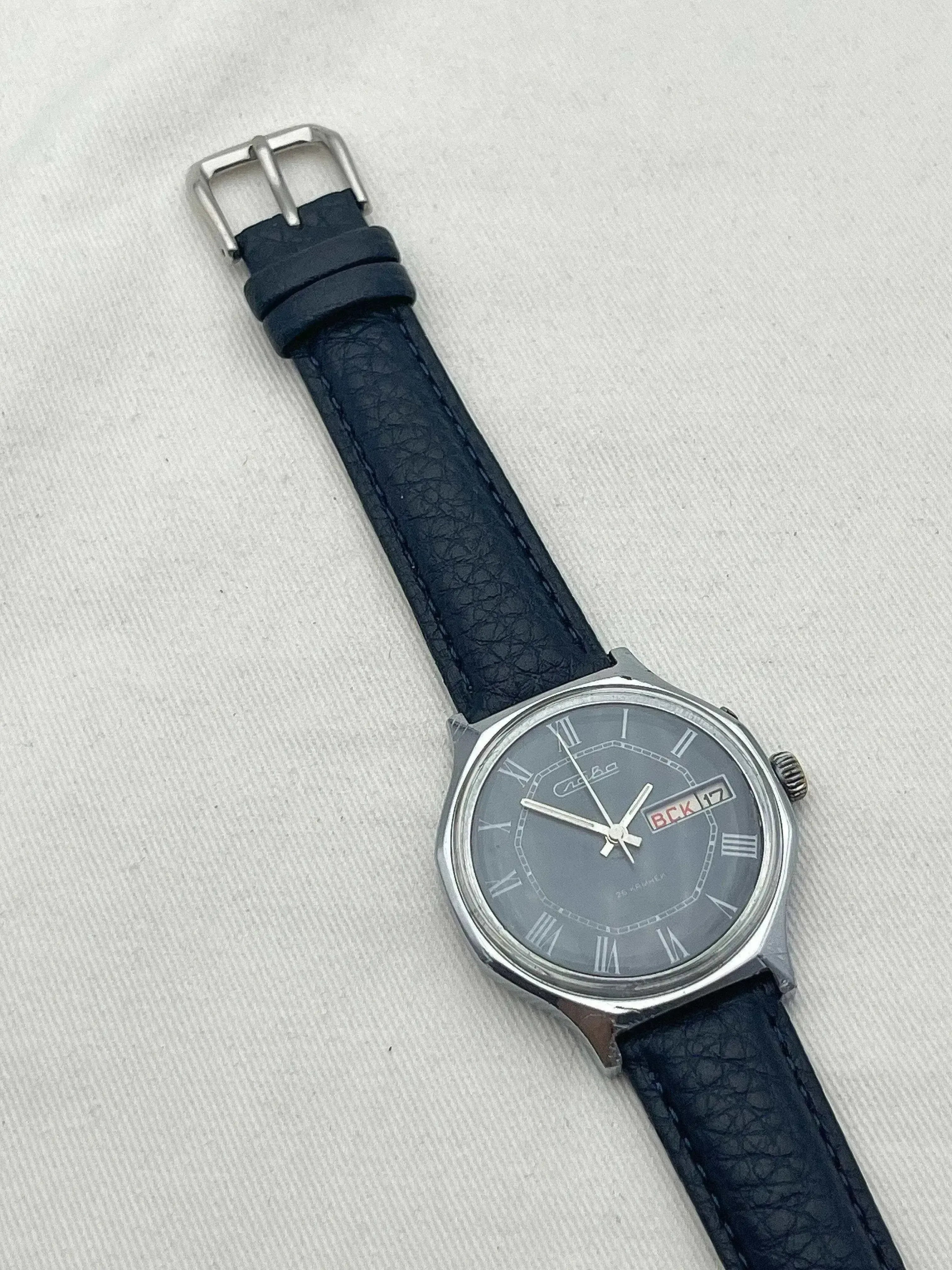 Omega vintage watch with gray dial, Roman numerals, blue leather strap