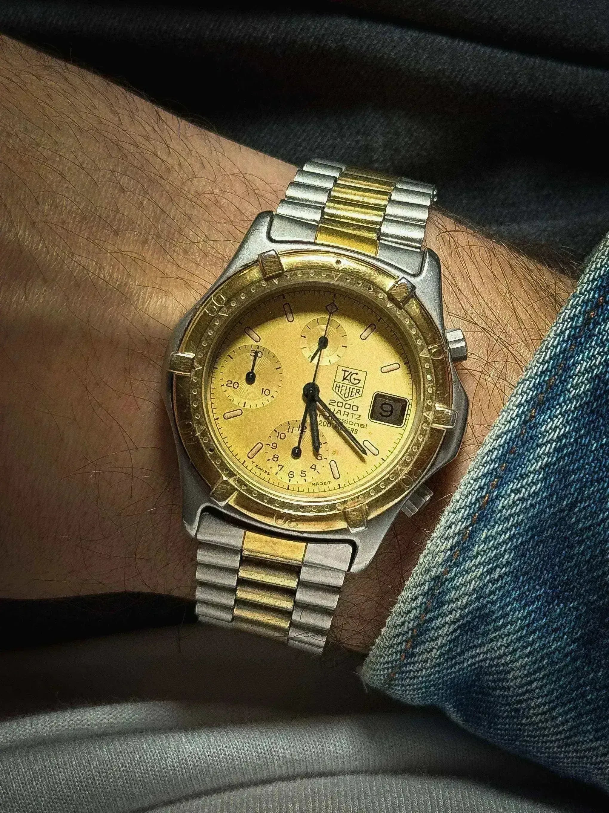TAG Heuer 2000 Quartz chronograph watch with gold dial, two-tone bracelet, worn on wrist