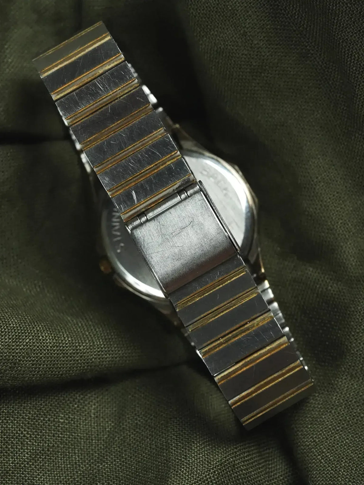 Vintage Seiko watch with two-tone steel and gold bracelet on dark fabric
