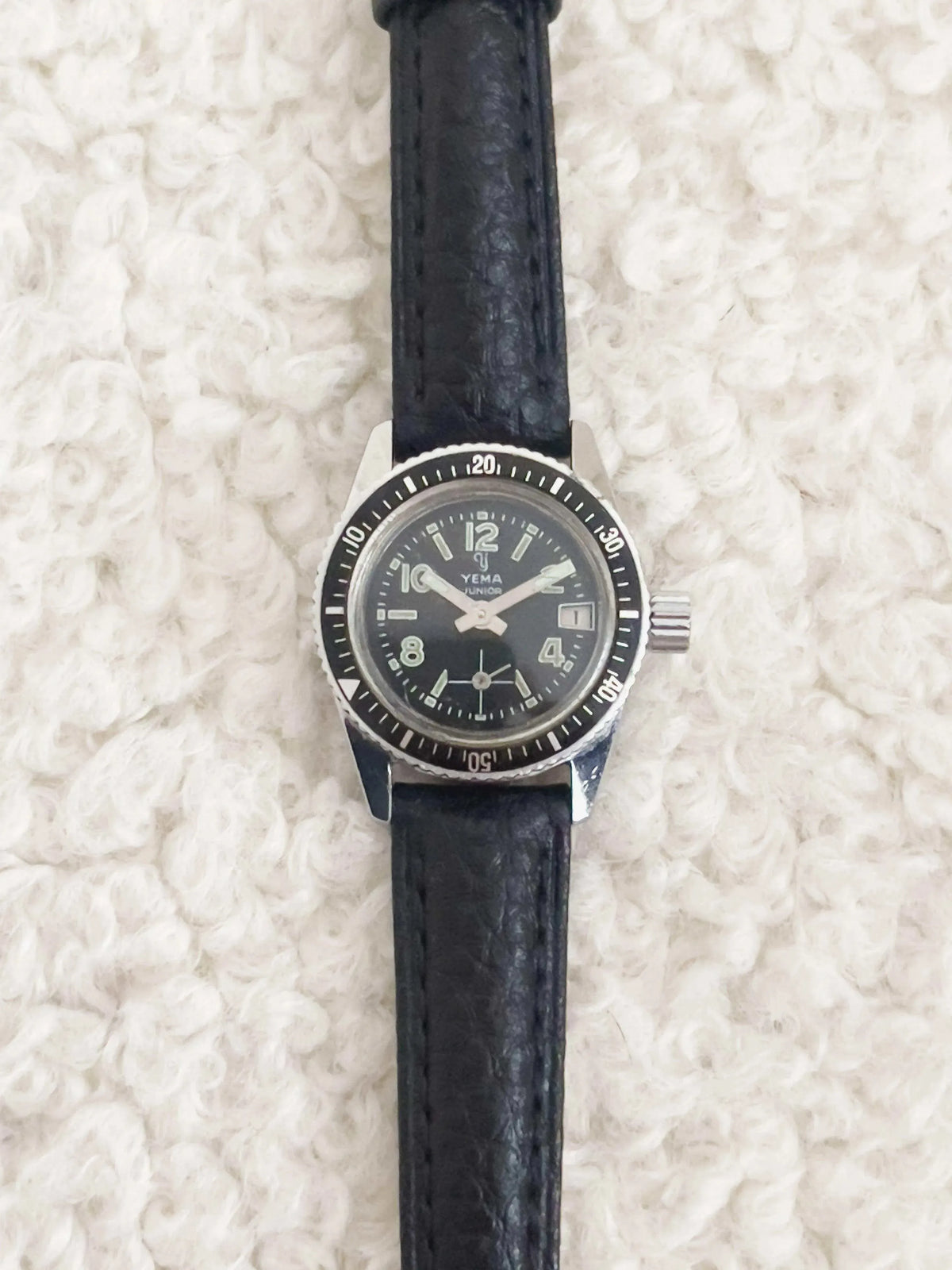 Yema Junior vintage watch with black dial, steel bezel, and black leather strap
