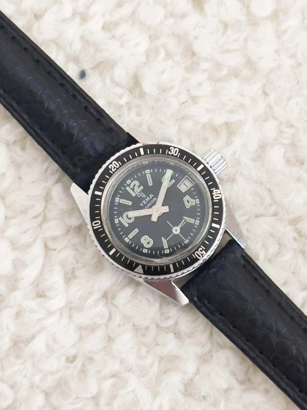 Yema Junior vintage watch with black dial, steel case, and black leather strap