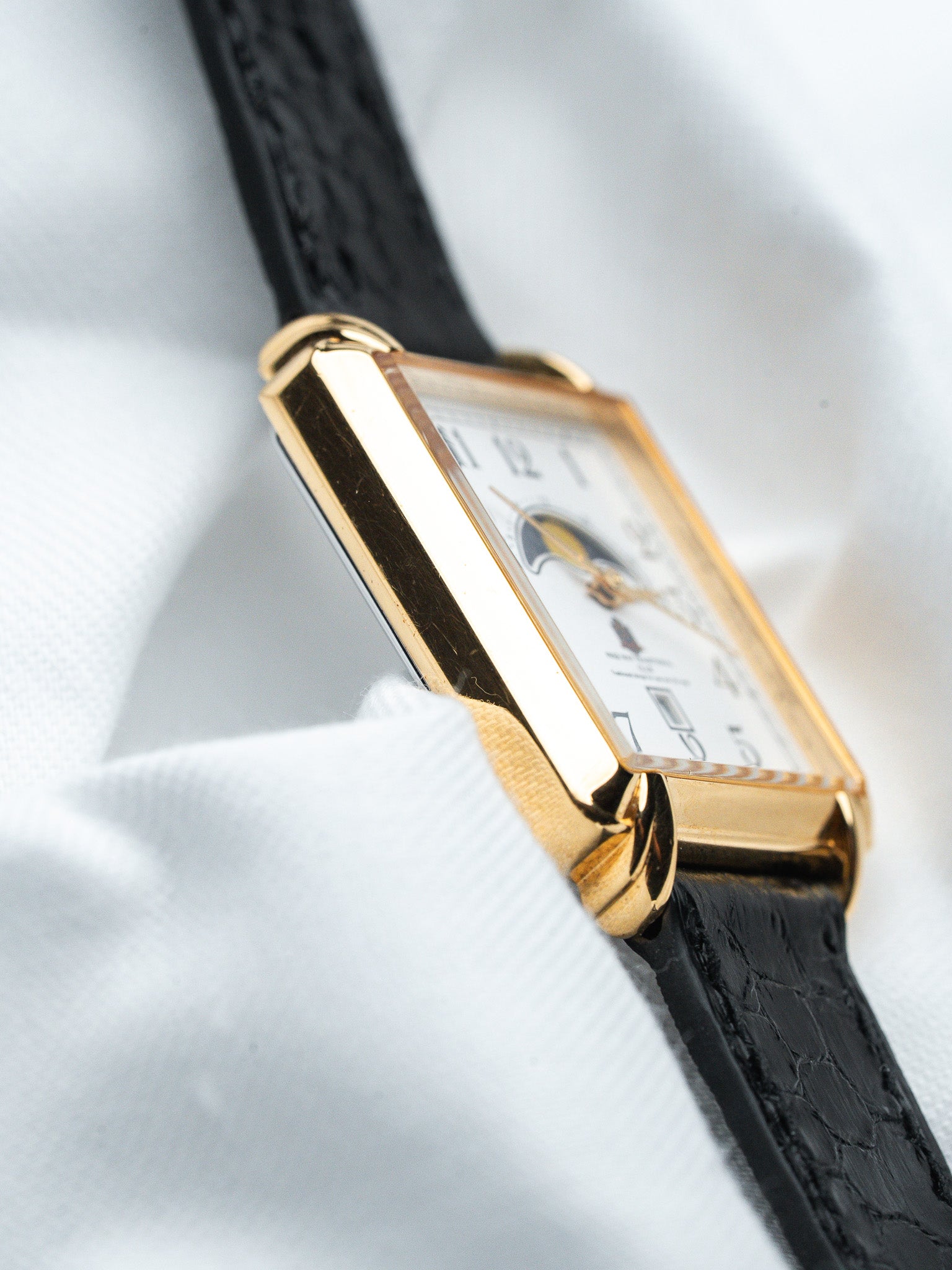 Cartier Tank vintage watch with gold case, white dial, black leather strap
