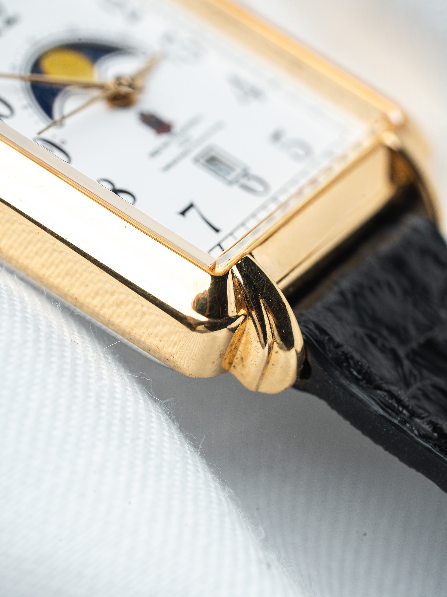 Vintage Cartier watch with gold case, white dial, moon phase, black alligator strap