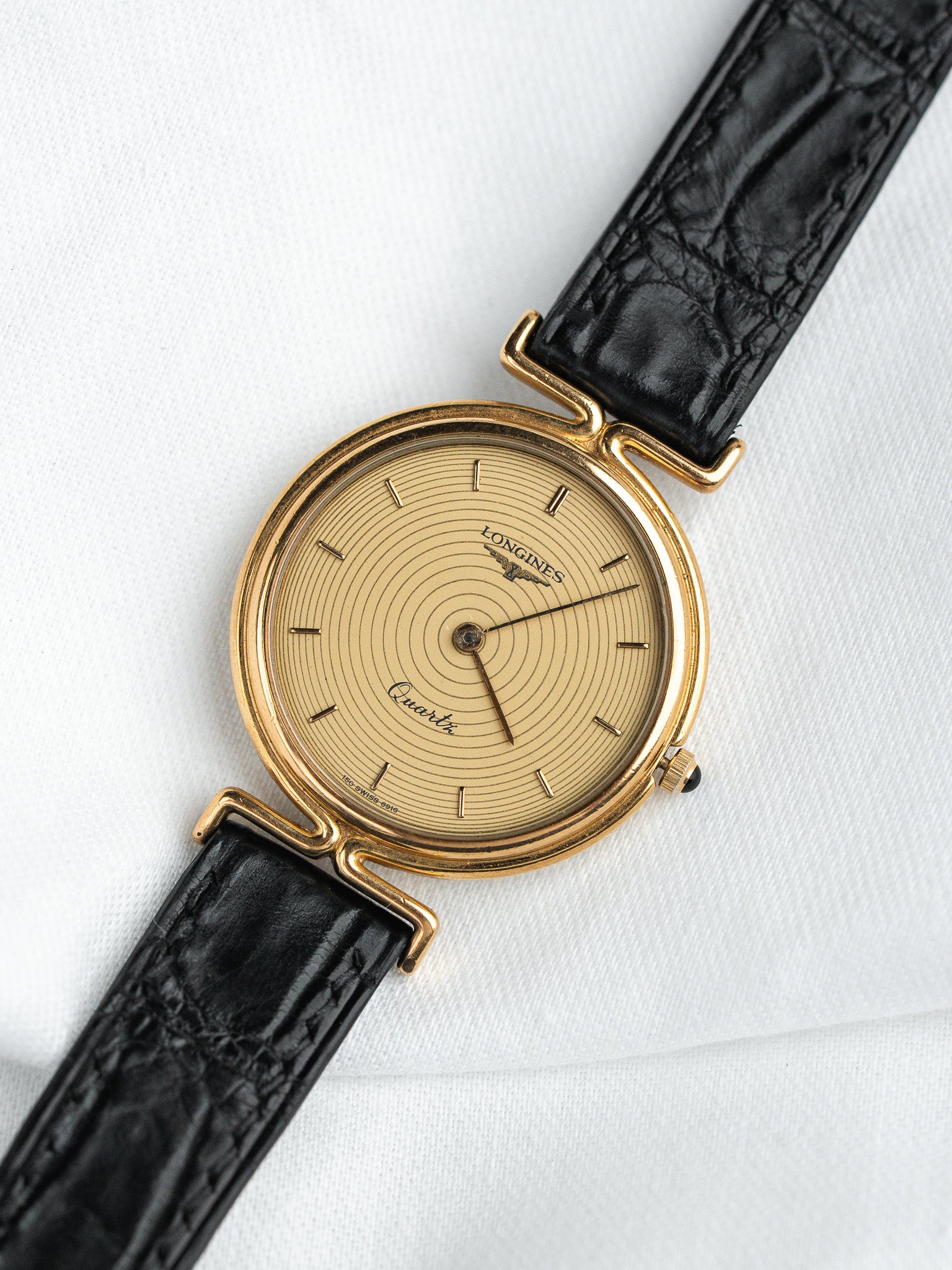 Longines vintage quartz watch with gold case, cream dial, black alligator strap