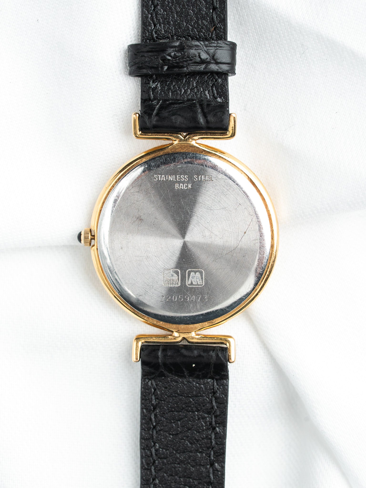 Vintage watch with gold case, stainless steel back, black leather strap