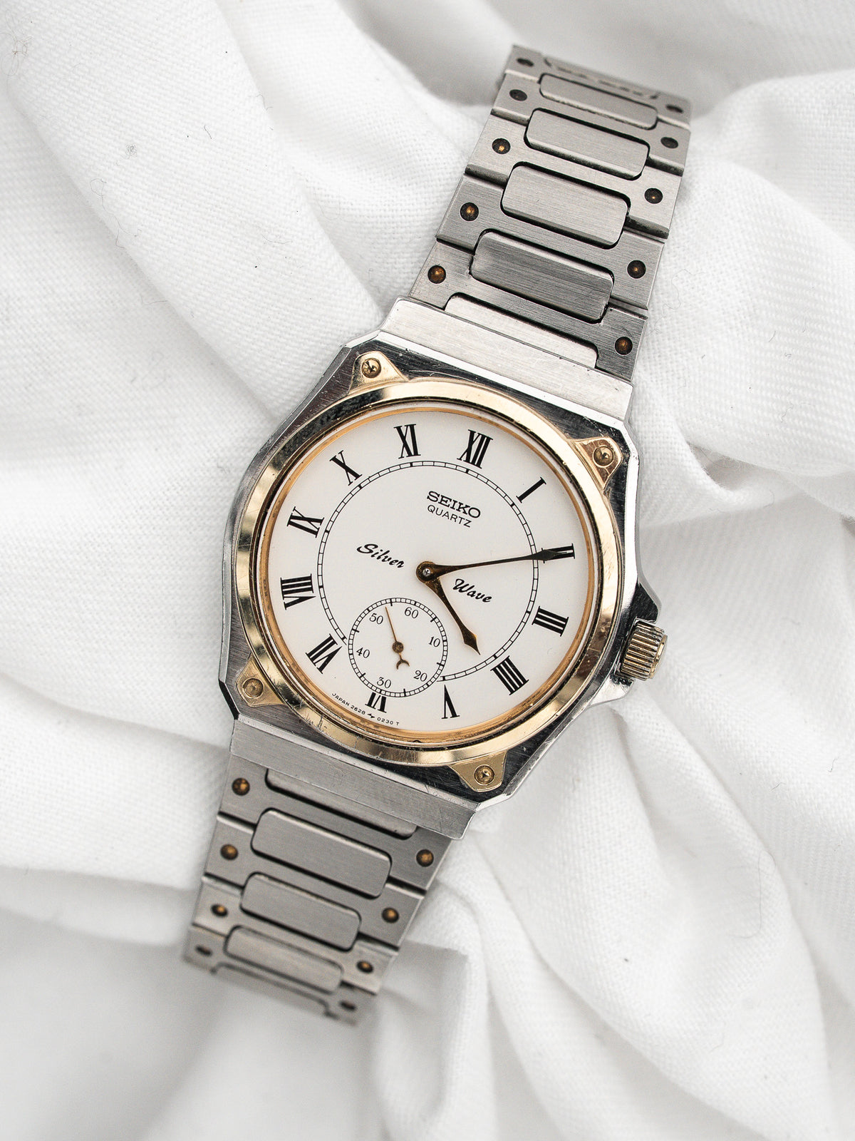 Vintage Seiko Silver Wave Watch in steel, white dial and Roman numerals.