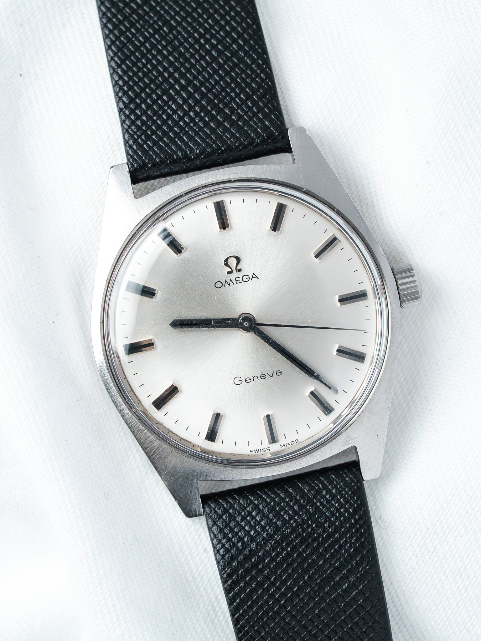 Omega Genève vintage watch with silver dial and black textured strap