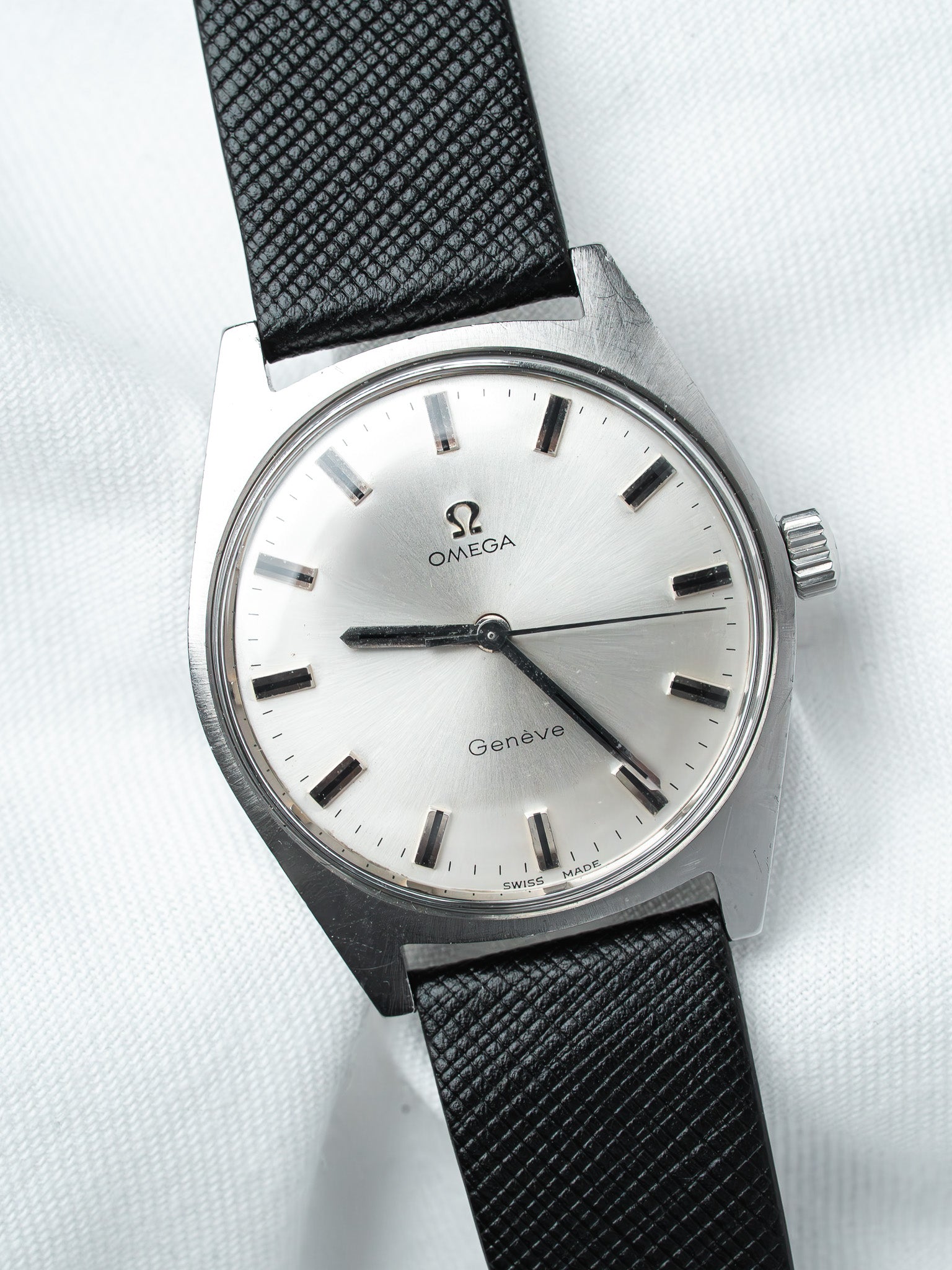 Omega Genève vintage watch with silver dial and black textured strap